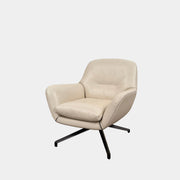 Two modern Minotti Jensen Swivel Chairs by Minotti face each other in a bright room with large windows overlooking the city, pale wood floors, and minimal decor for a contemporary, sophisticated look.