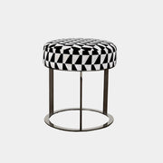 The B&B Italia Frank Ottoman features a black and white geometric cushion on a metal base with three vertical supports and a circular footrest.