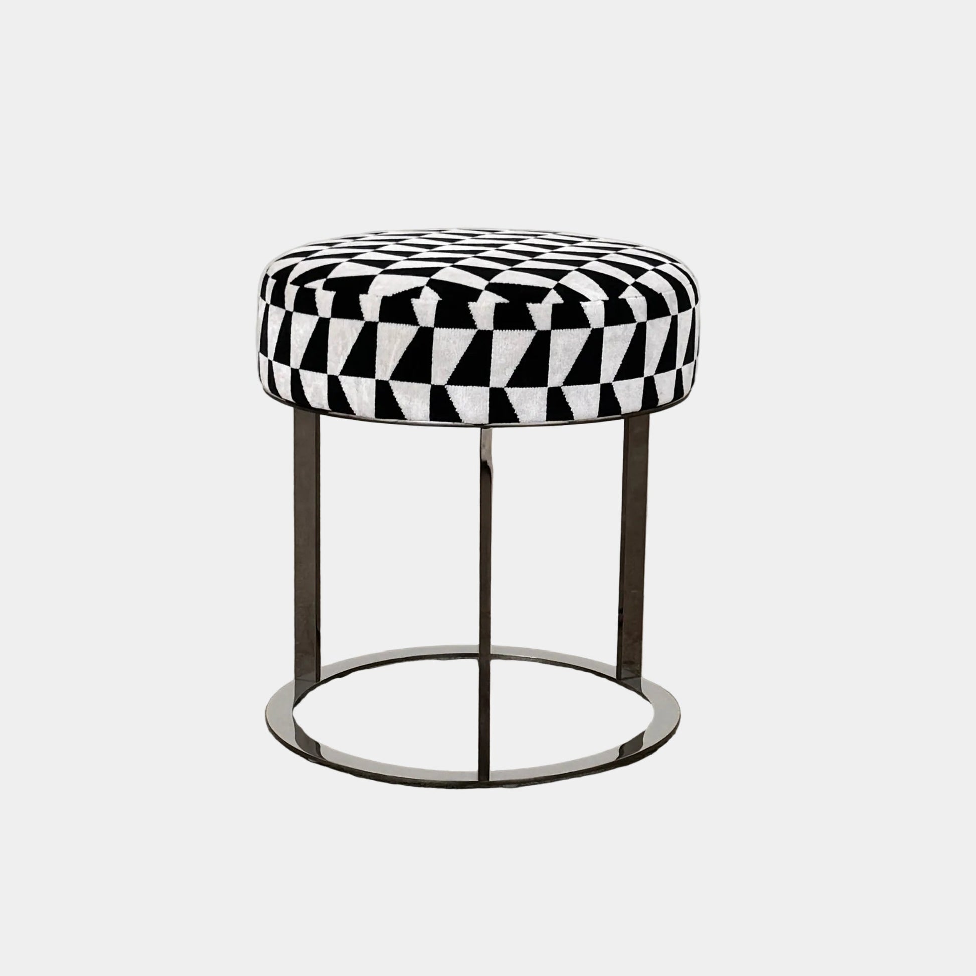 The B&B Italia Frank Ottoman features a black and white geometric cushion on a metal base with three vertical supports and a circular footrest.