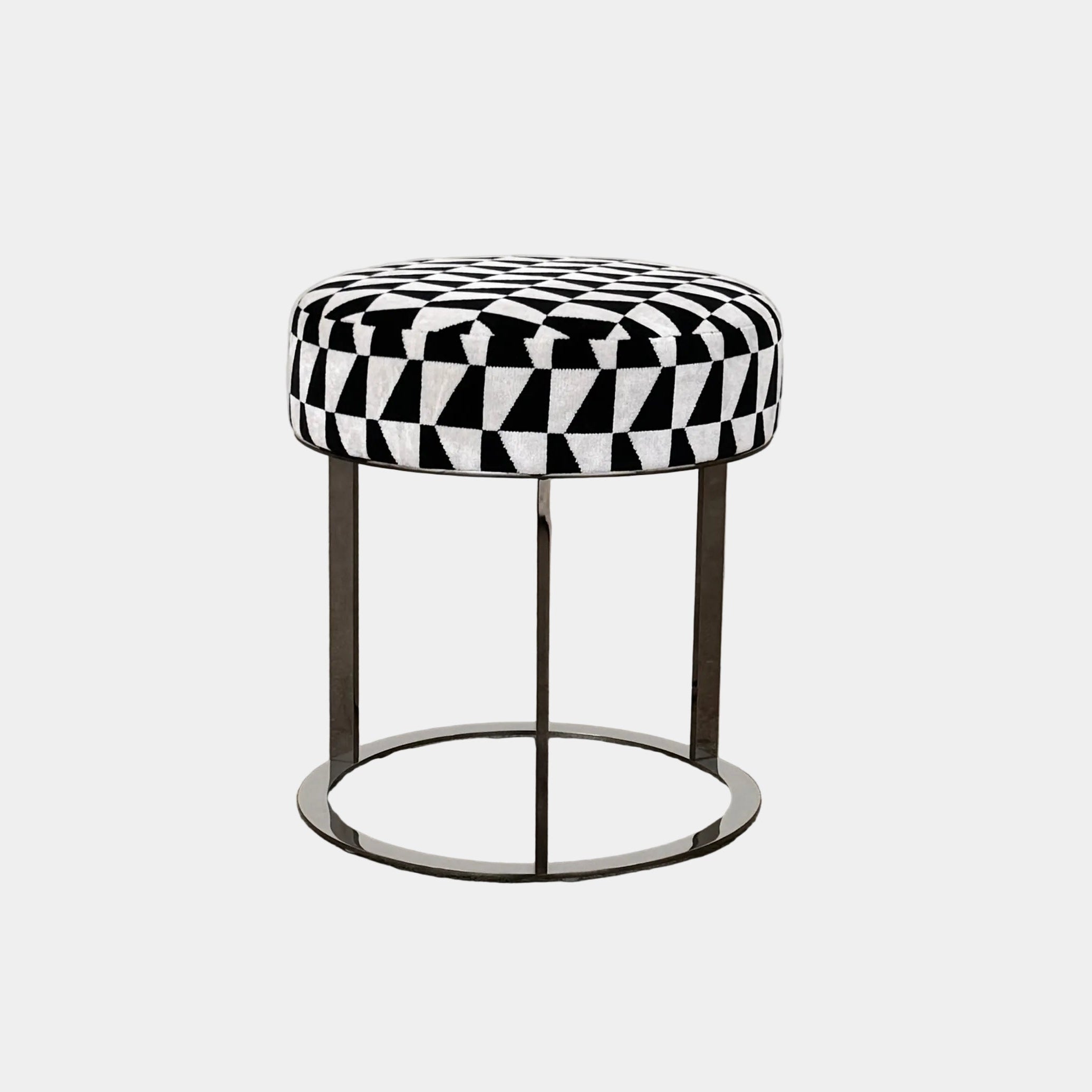 The B&B Italia Frank Ottoman features a black and white geometric cushion on a metal base with three vertical supports and a circular footrest.