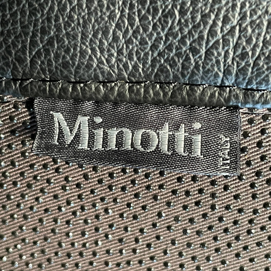 A Minotti Hamilton Black Leather Sofa with multiple cushions, designed by Rodolfo Dordoni, isolated on a white background.