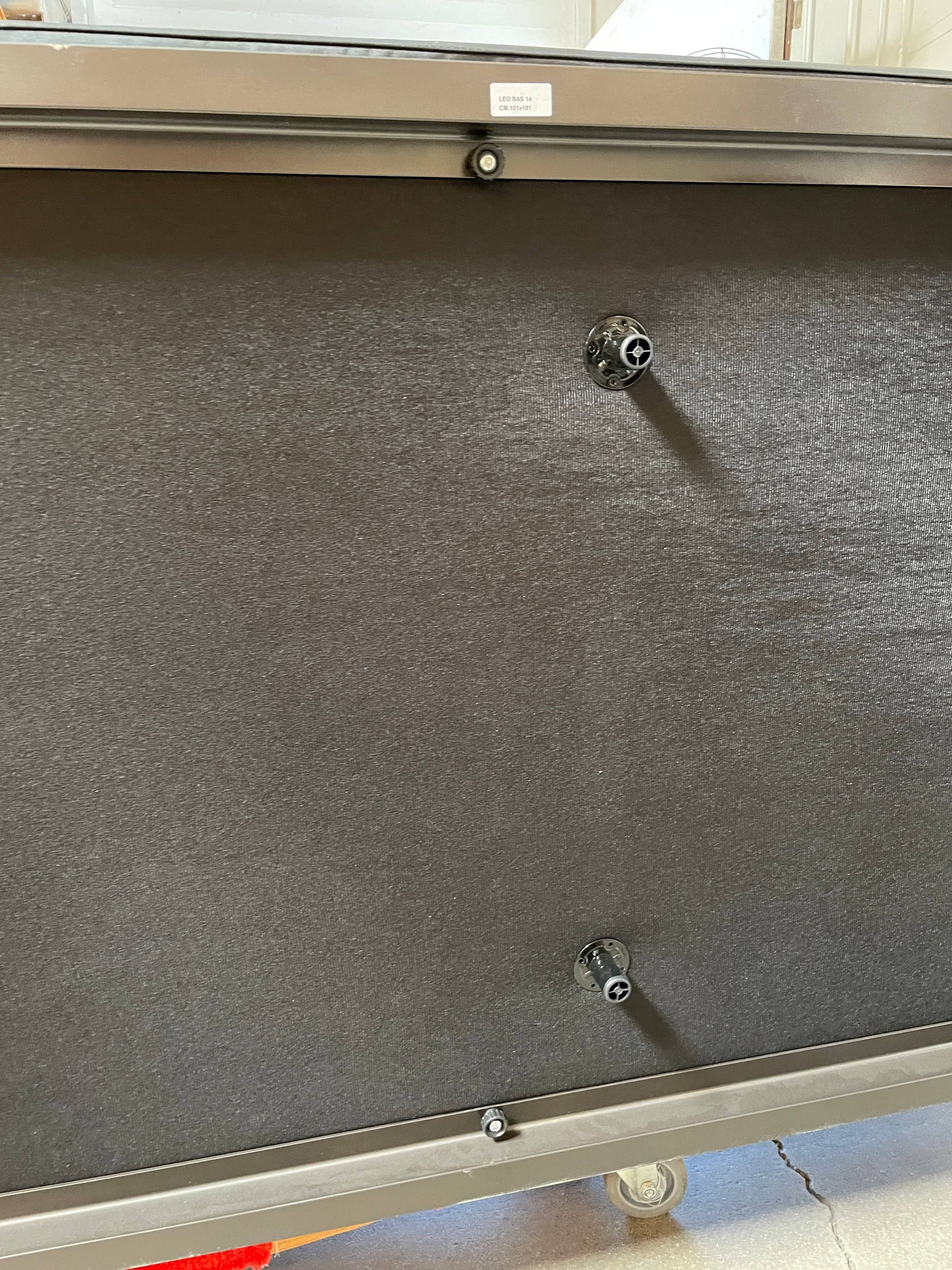 A Minotti Hamilton Black Leather Sofa with multiple cushions, designed by Rodolfo Dordoni, isolated on a white background.