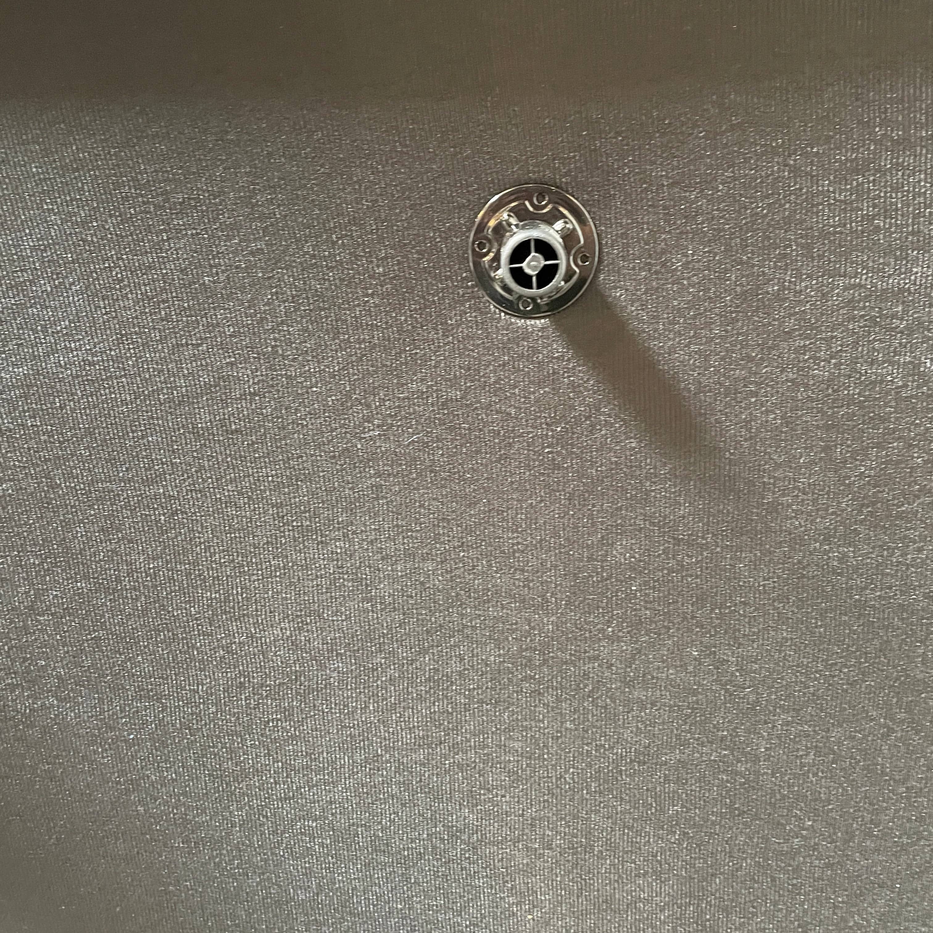 A Minotti Hamilton Black Leather Sofa with multiple cushions, designed by Rodolfo Dordoni, isolated on a white background.