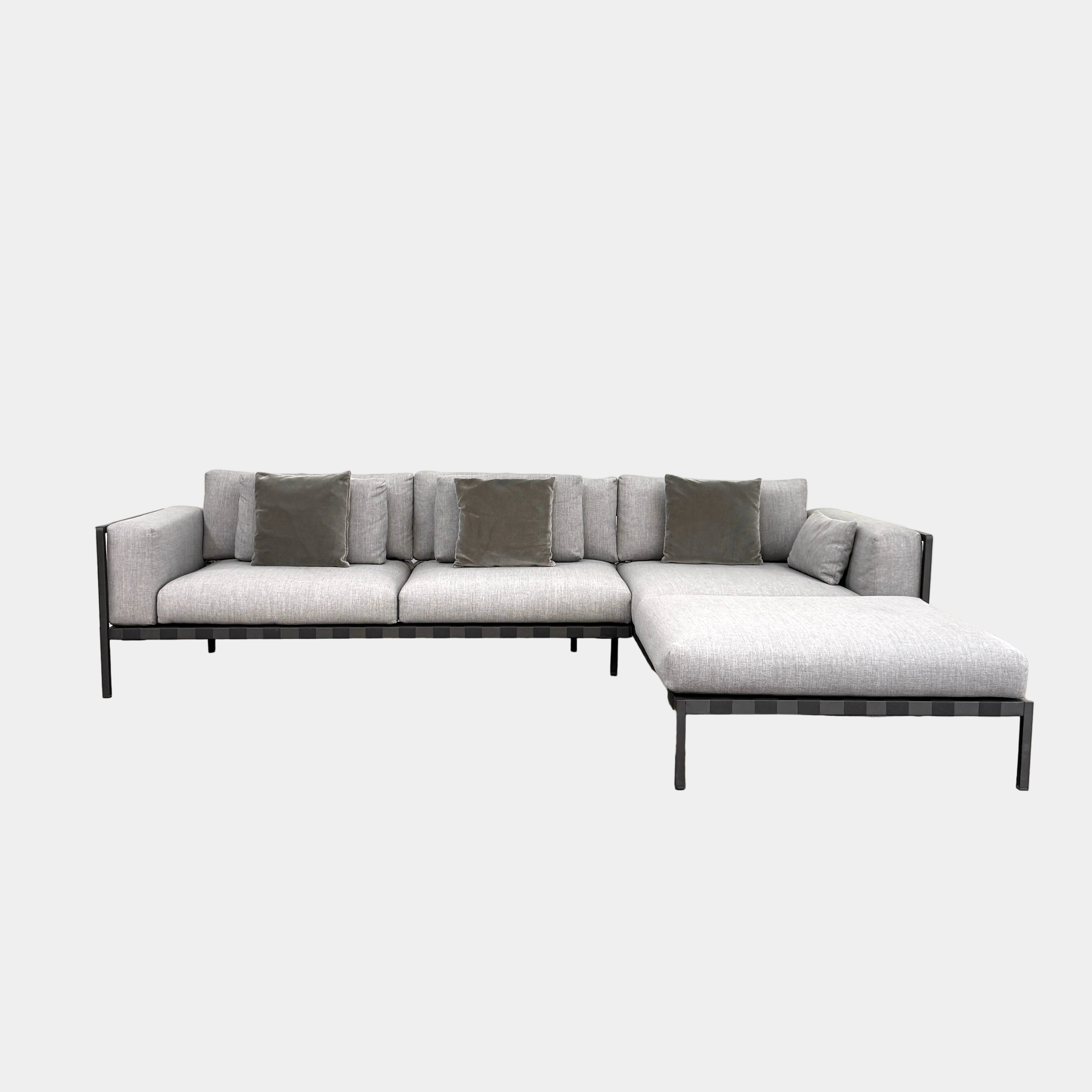 The Tribu Natal Alu Outdoor Sectional Sofa by Tribú features light gray cushions, five dark gray throw pillows, and a sleek black aluminum frame—perfect for adding modern style to your patio.