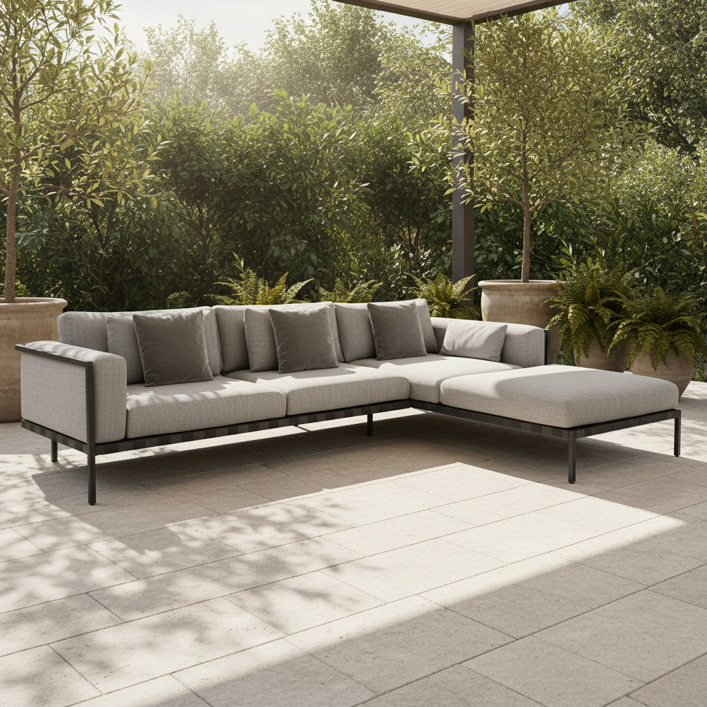 The Tribu Natal Alu Outdoor Sectional Sofa by Tribú features light gray cushions, five dark gray throw pillows, and a sleek black aluminum frame—perfect for adding modern style to your patio.