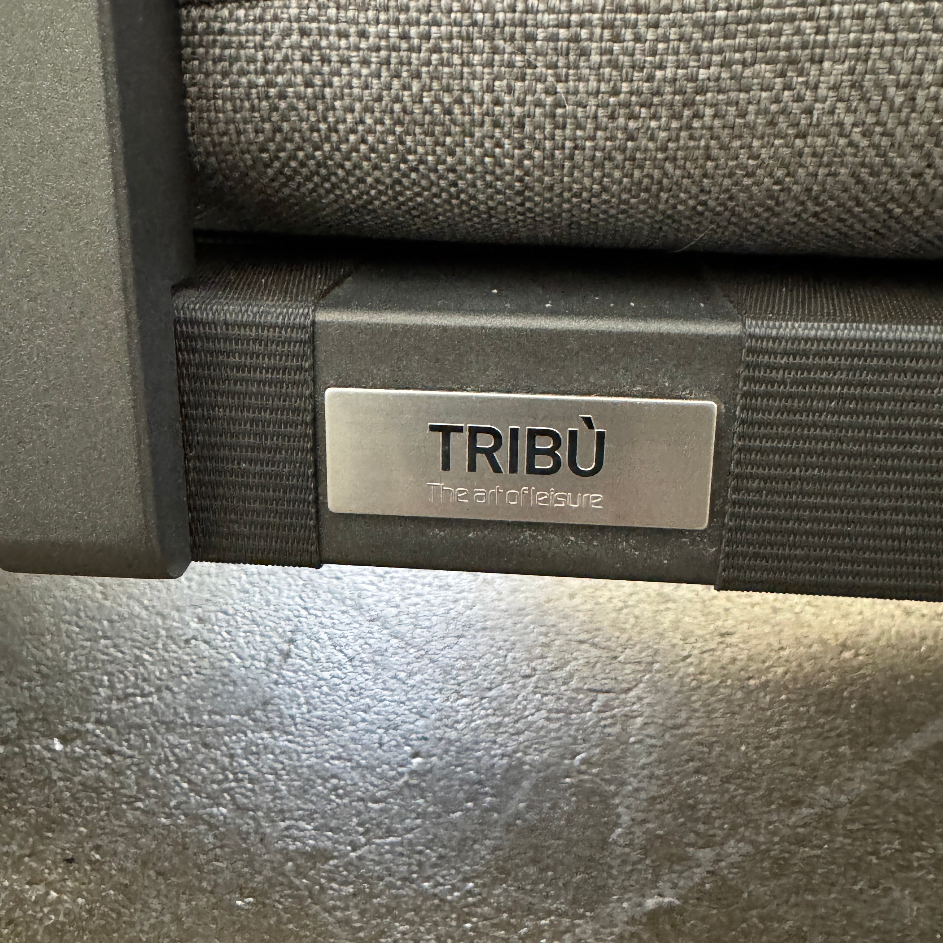 The Tribu Natal Alu Outdoor Sectional Sofa by Tribú features light gray cushions, five dark gray throw pillows, and a sleek black aluminum frame—perfect for adding modern style to your patio.