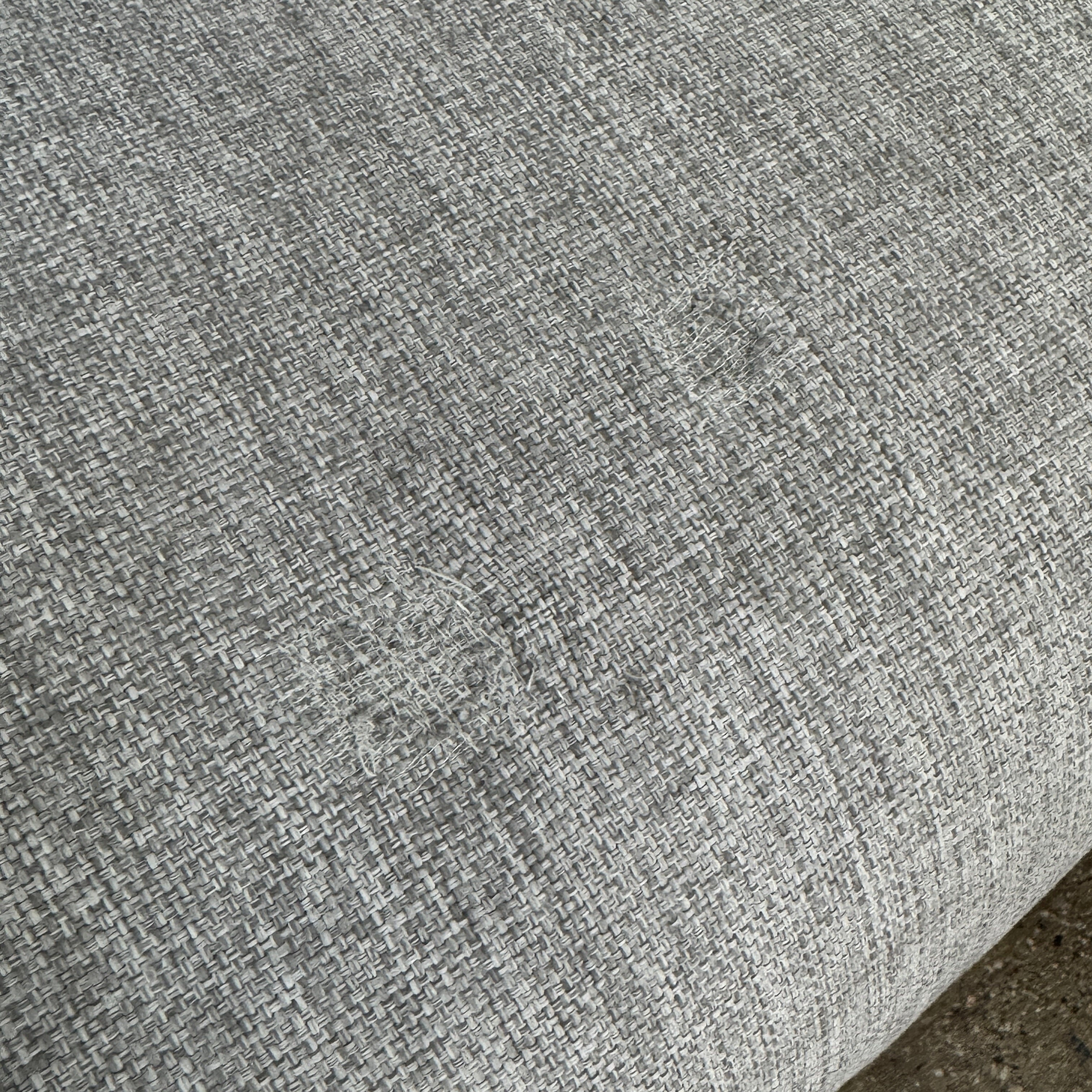 The Tribu Natal Alu Outdoor Sectional Sofa by Tribú features light gray cushions, five dark gray throw pillows, and a sleek black aluminum frame—perfect for adding modern style to your patio.