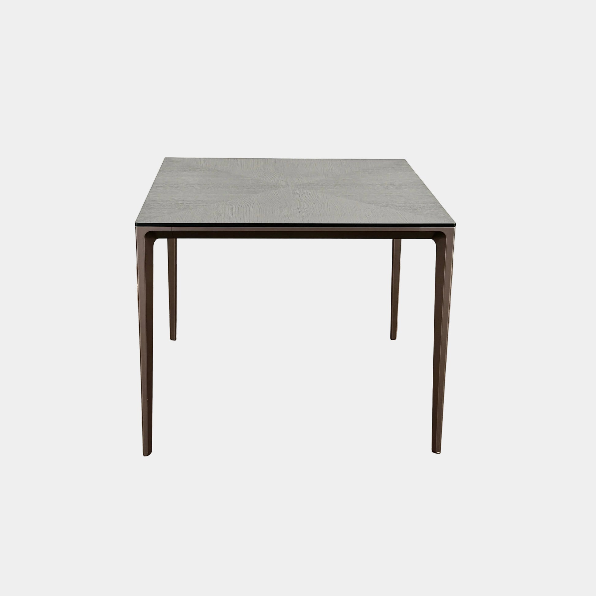 The Rimadesio Long Island Table by Rimadesio features a square black oak top with a dark wood finish, four slender legs, and modern Italian design, displayed against a plain white background.