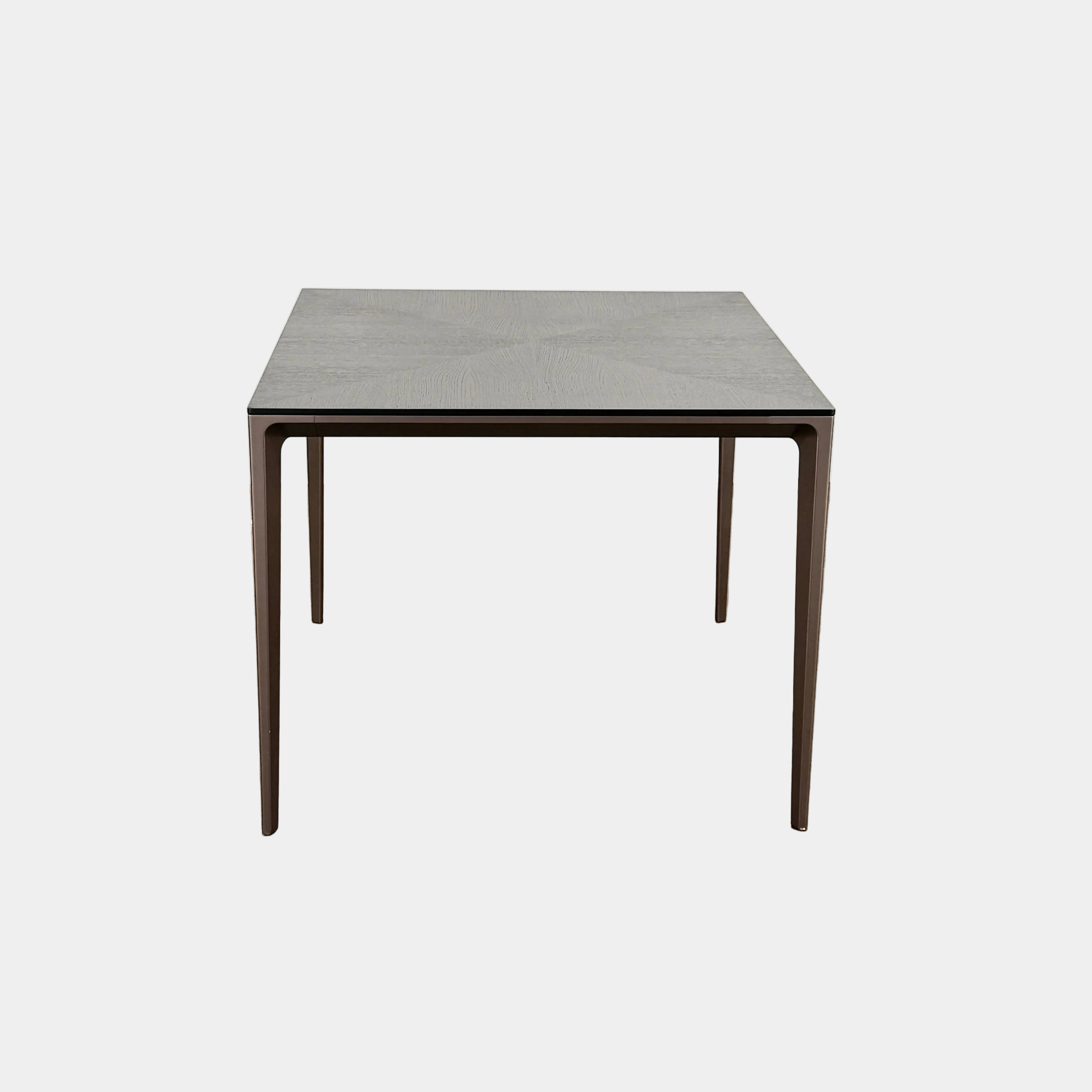 The Rimadesio Long Island Table by Rimadesio features a square black oak top with a dark wood finish, four slender legs, and modern Italian design, displayed against a plain white background.
