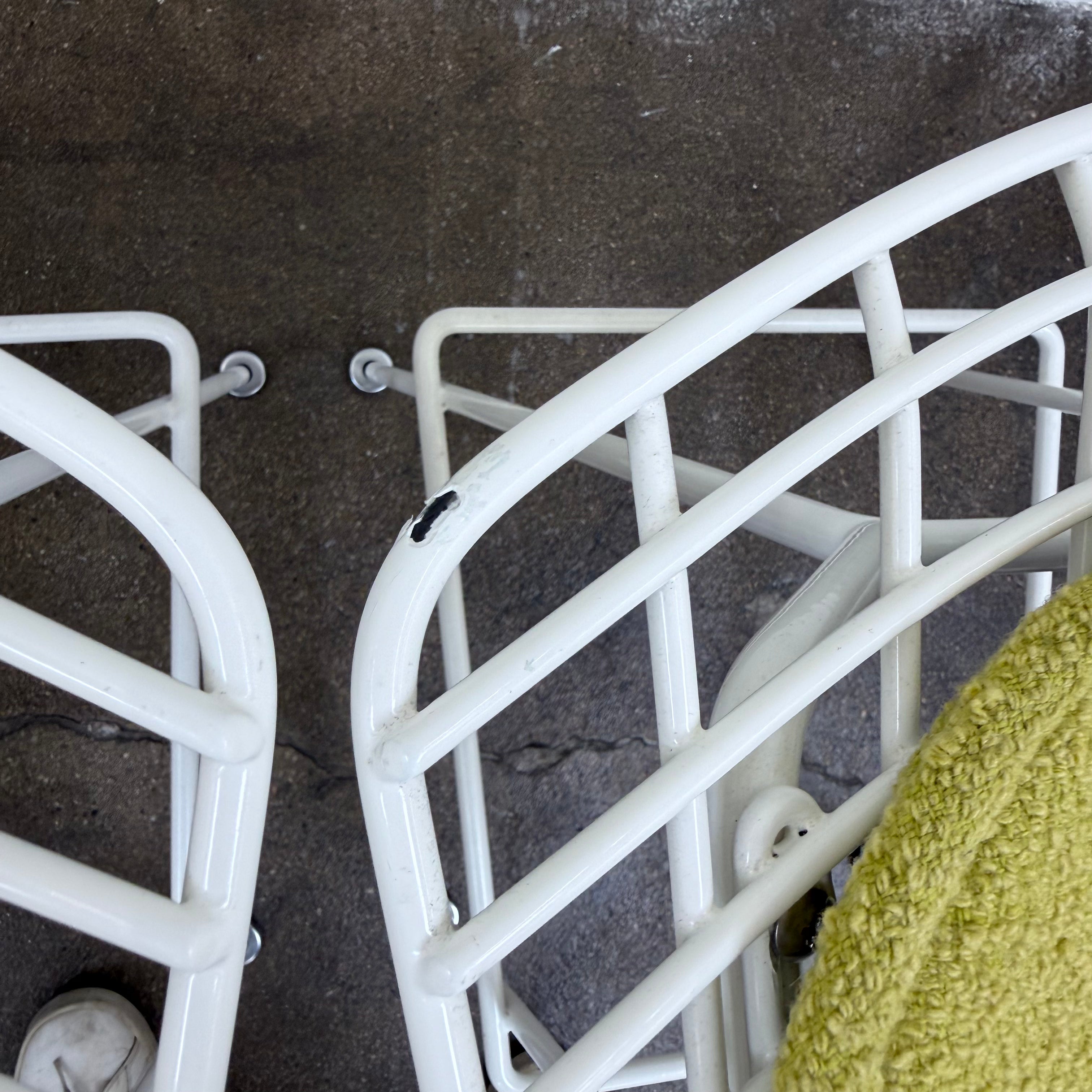 Two white Knoll Harry Bertoia Wire Counter Stools with light green seat cushions.