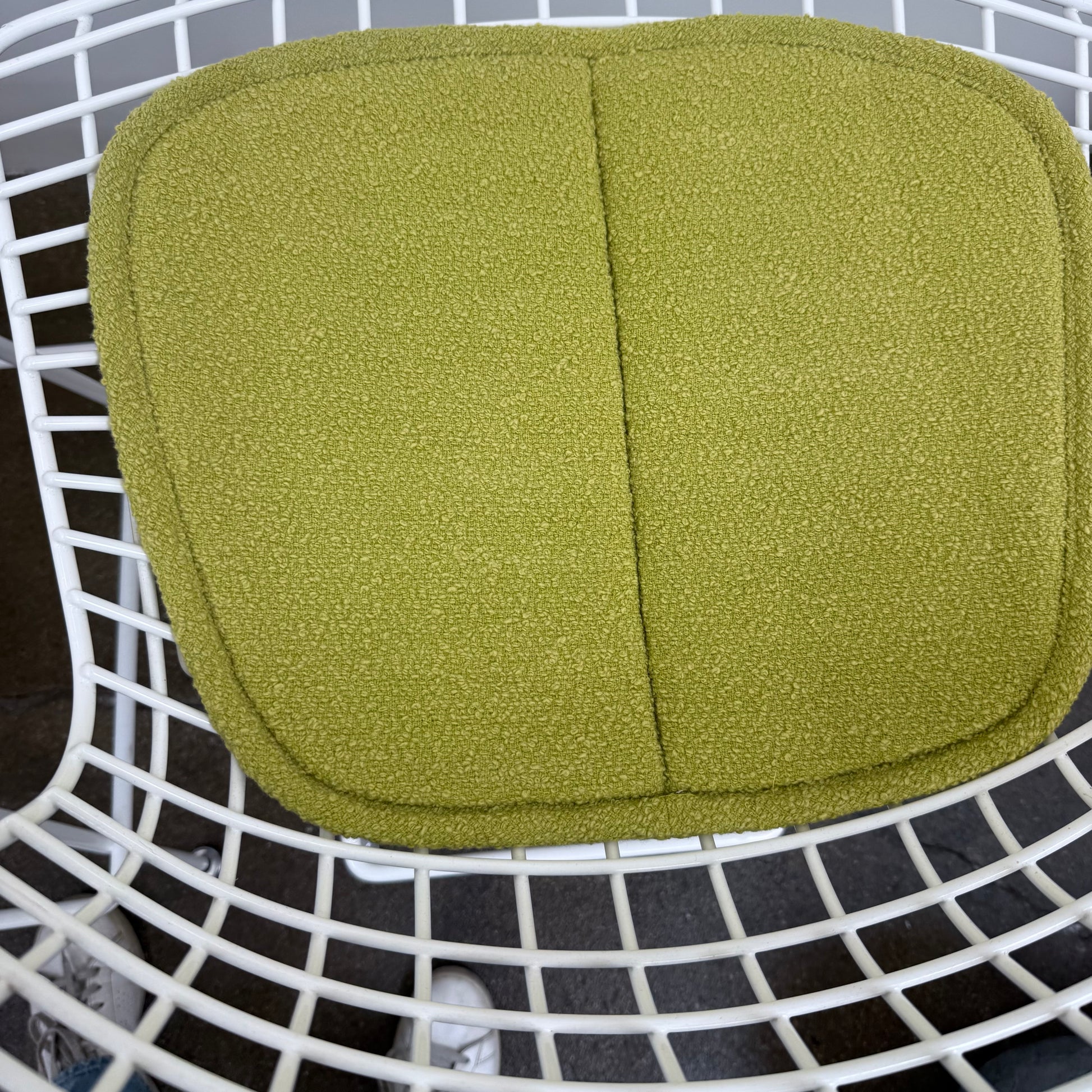 Two white Knoll Harry Bertoia Wire Counter Stools with light green seat cushions.
