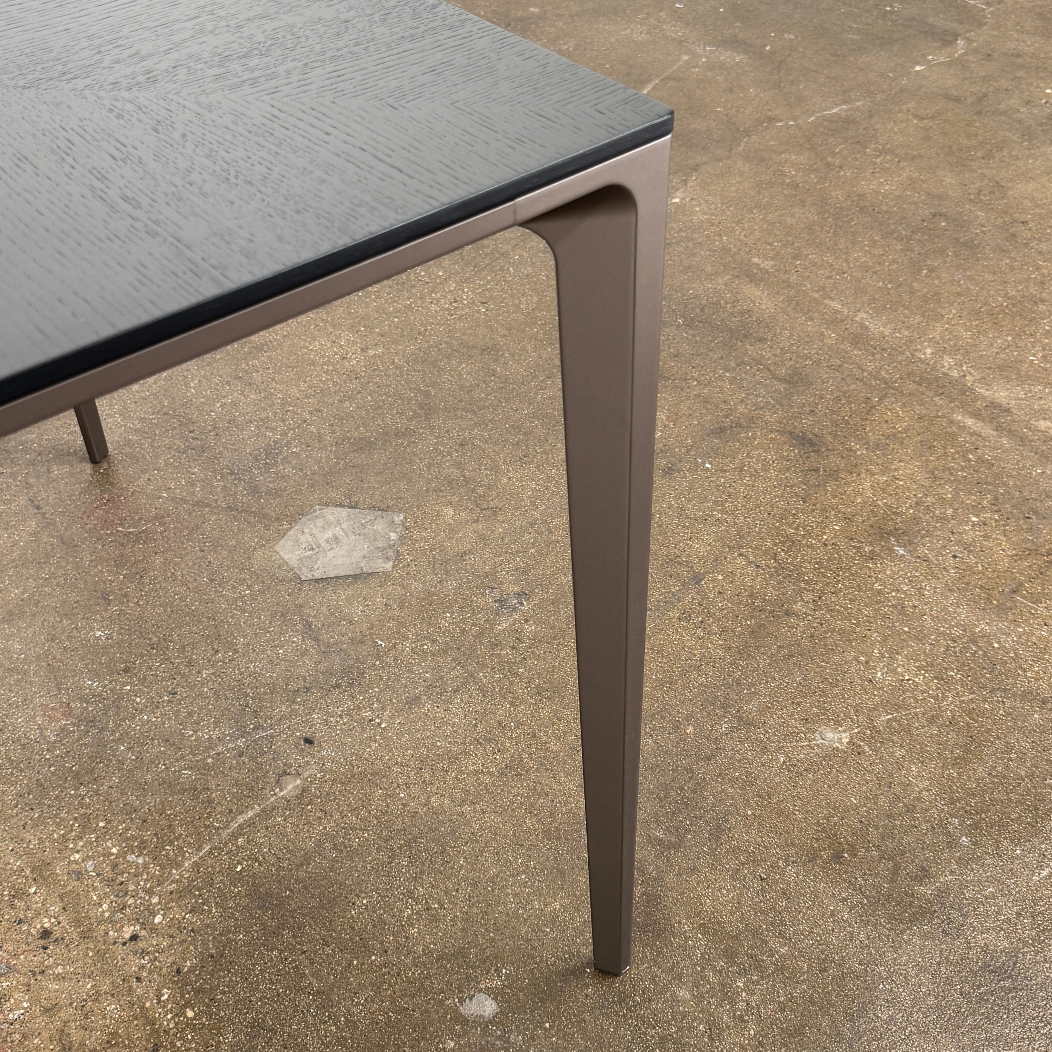 The Rimadesio Long Island Table by Rimadesio features a square black oak top with a dark wood finish, four slender legs, and modern Italian design, displayed against a plain white background.