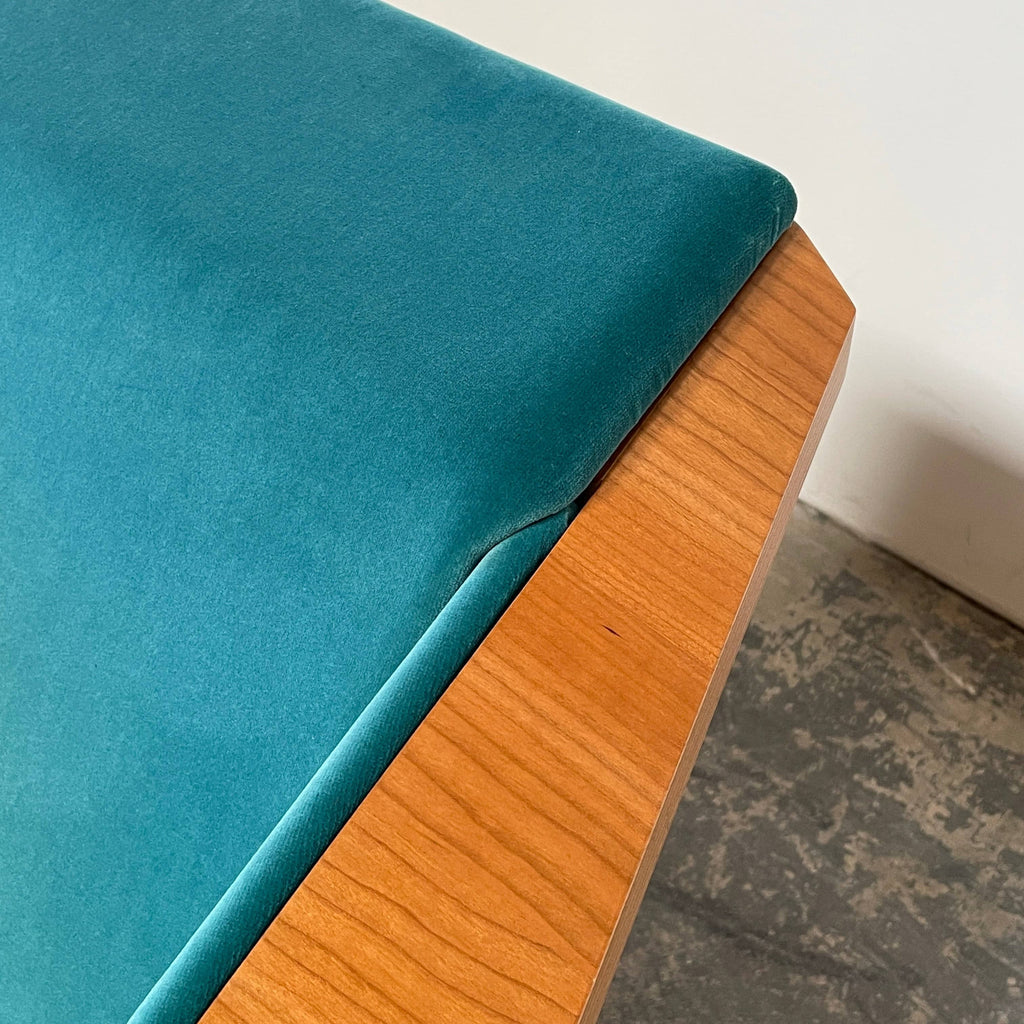 A Taliesin 1 Armchair by Frank Lloyd Wright for Cassina with a blue cushion.