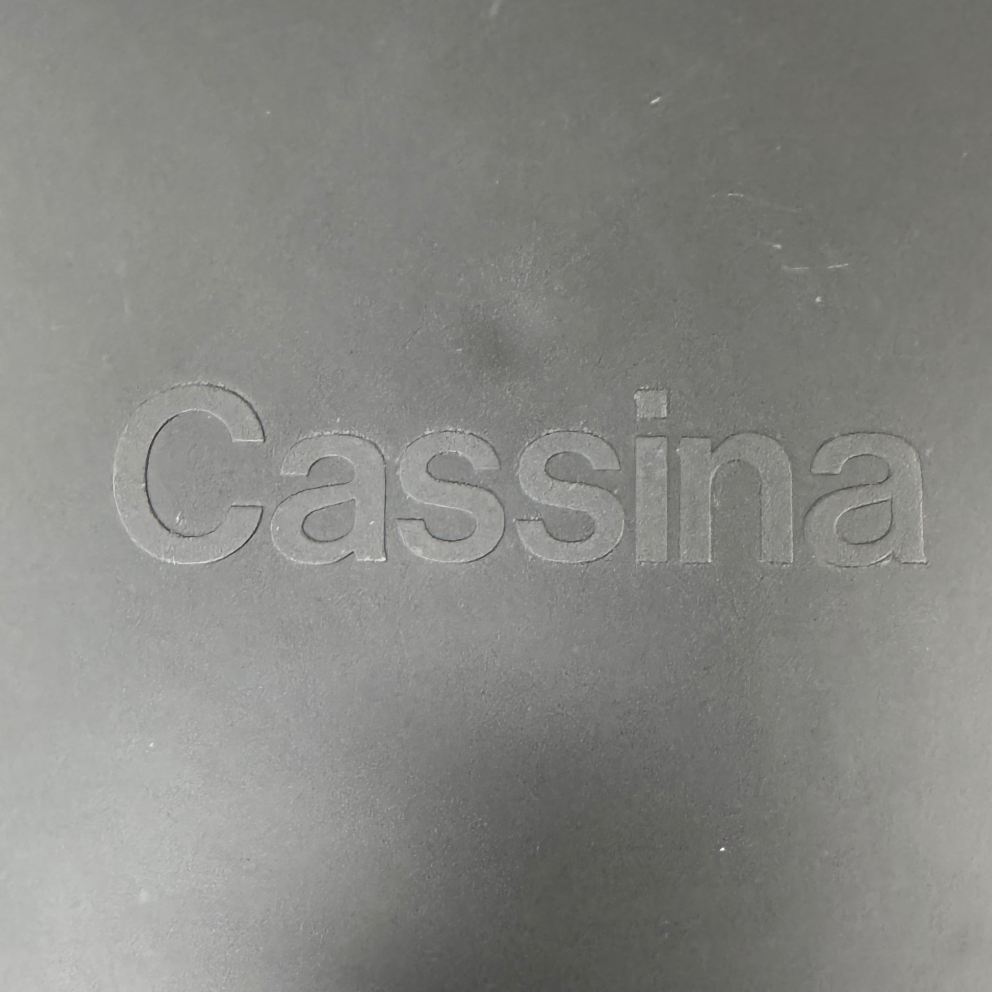 A pair of Cassina Cab 413 Dining Chairs by Cassina, featuring taupe leather and a modern design, are positioned side by side against a plain white background.