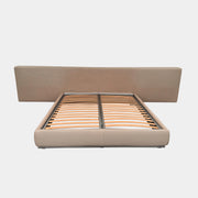 The Flexform Groundpiece Cal King Size Bed by Flexform features a beige upholstered leather frame, wide headboard, and exposed wooden slats, shown against a plain white background.