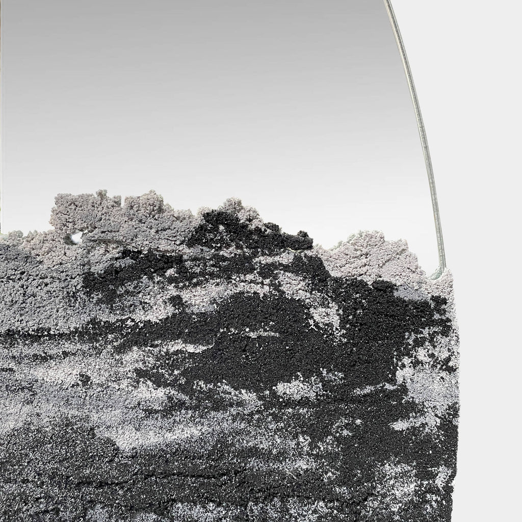 A Fernando Mastrangelo Studio Drift 48" Mirror with a black and white painting on it.