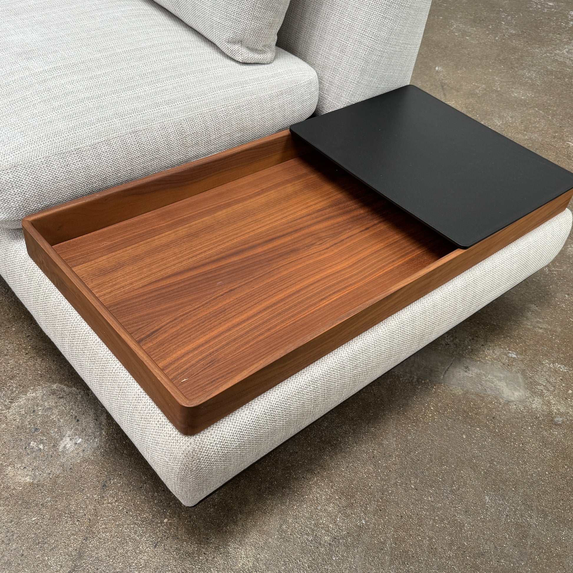 The Walter Knoll Tama Living 3 Piece Modular Sofa by Walter Knoll features an L-shaped design in light gray luxury fabric, matching cushions, and a built-in wooden side table on the right.