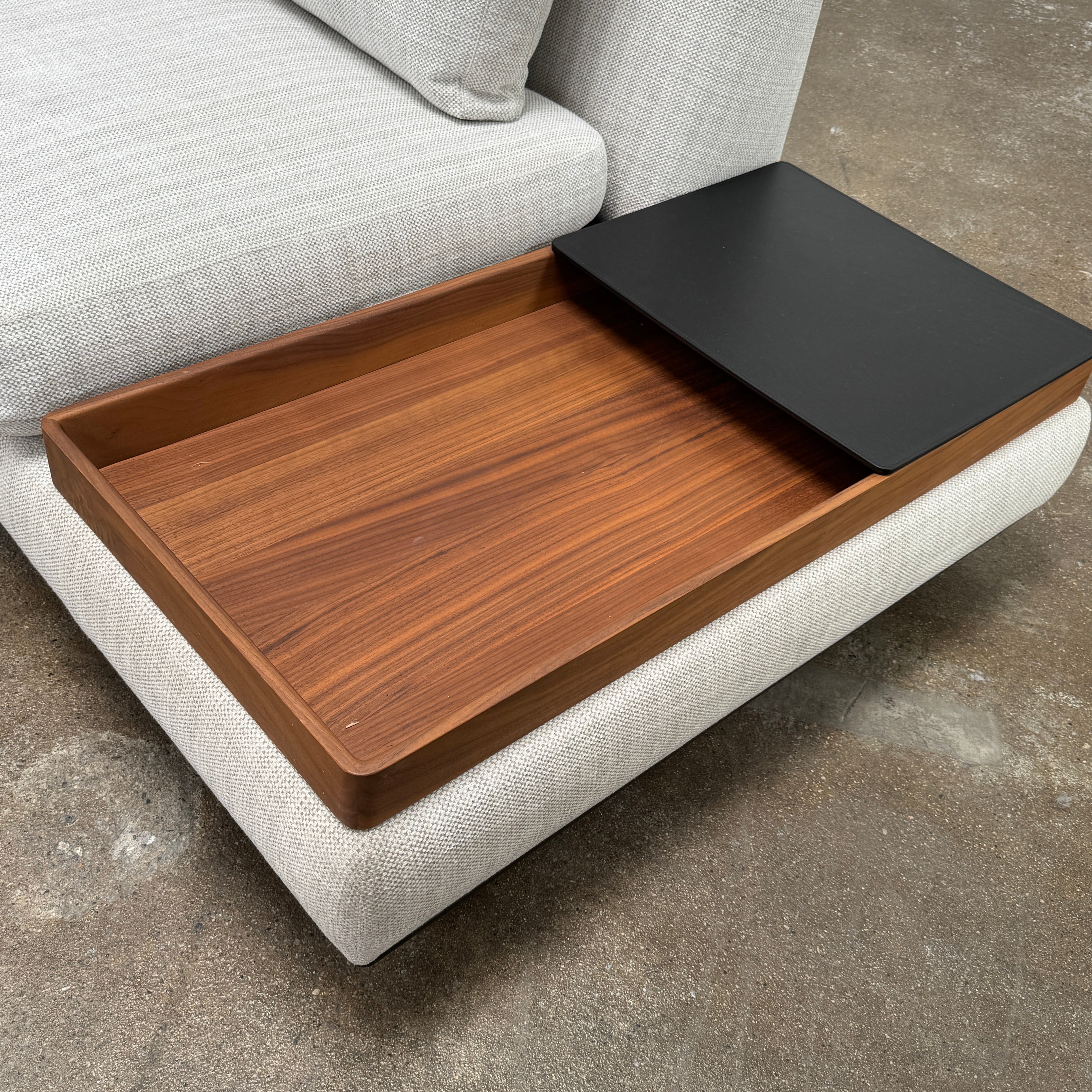 The Walter Knoll Tama Living 3 Piece Modular Sofa by Walter Knoll features an L-shaped design in light gray luxury fabric, matching cushions, and a built-in wooden side table on the right.