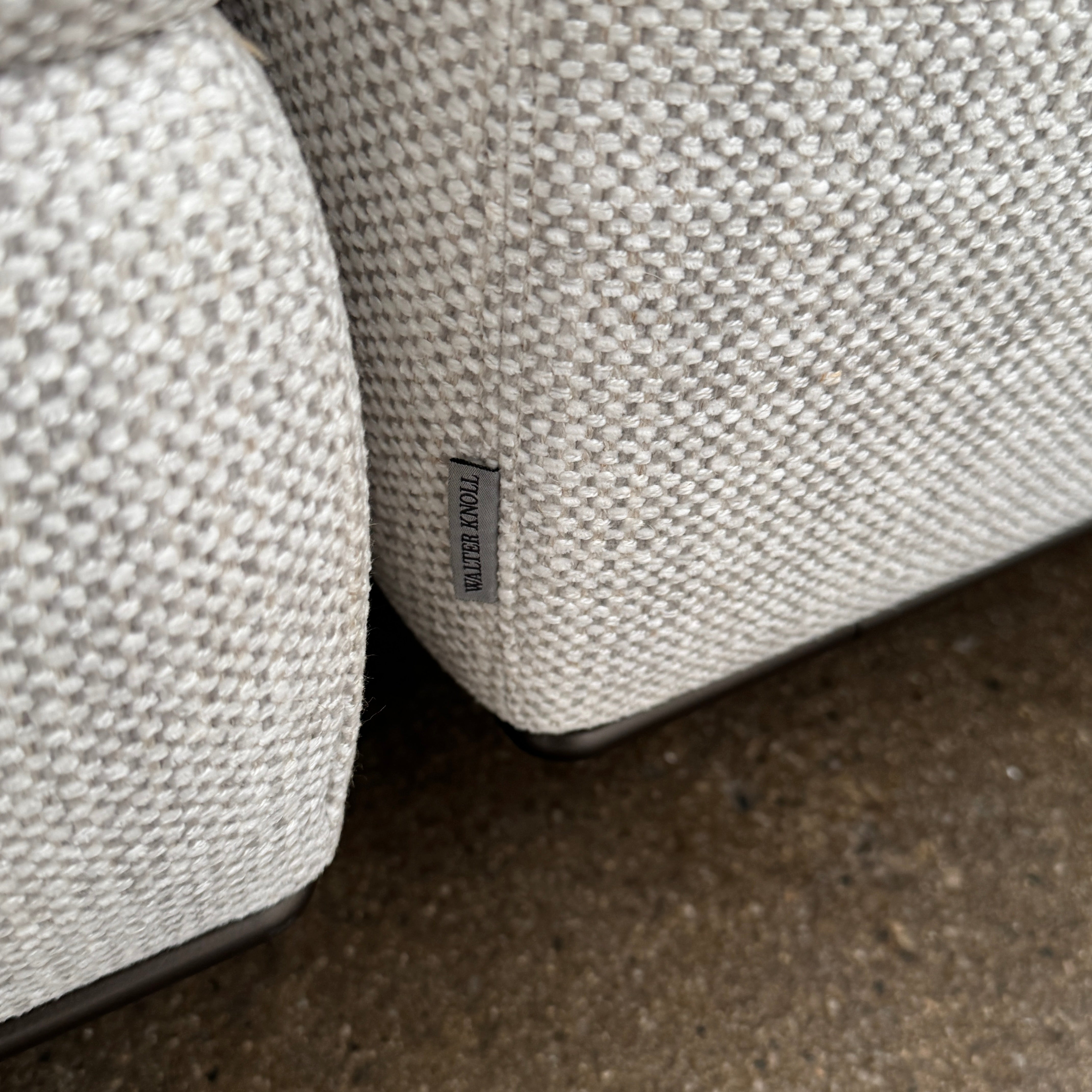 The Walter Knoll Tama Living 3 Piece Modular Sofa by Walter Knoll features an L-shaped design in light gray luxury fabric, matching cushions, and a built-in wooden side table on the right.