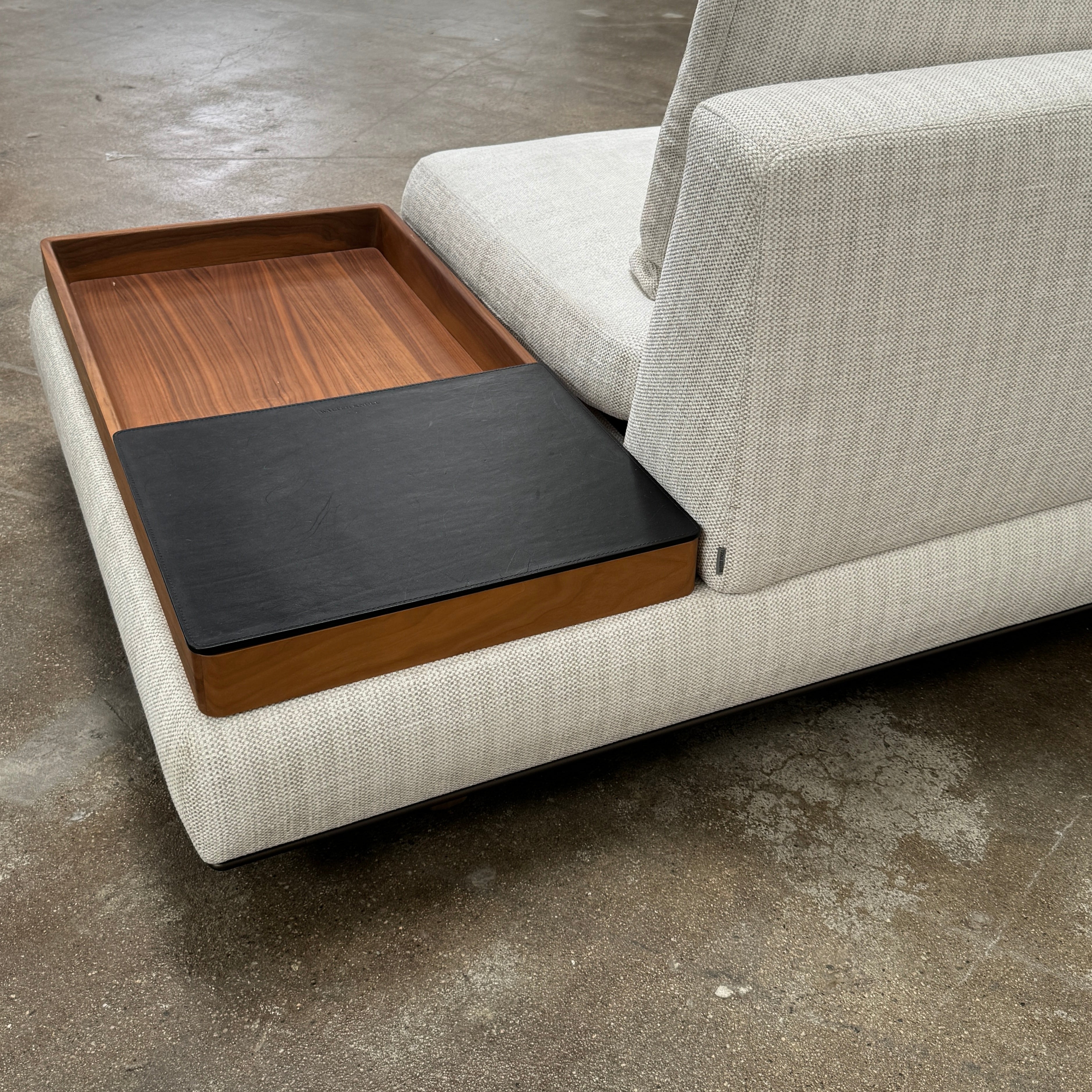 The Walter Knoll Tama Living 3 Piece Modular Sofa by Walter Knoll features an L-shaped design in light gray luxury fabric, matching cushions, and a built-in wooden side table on the right.