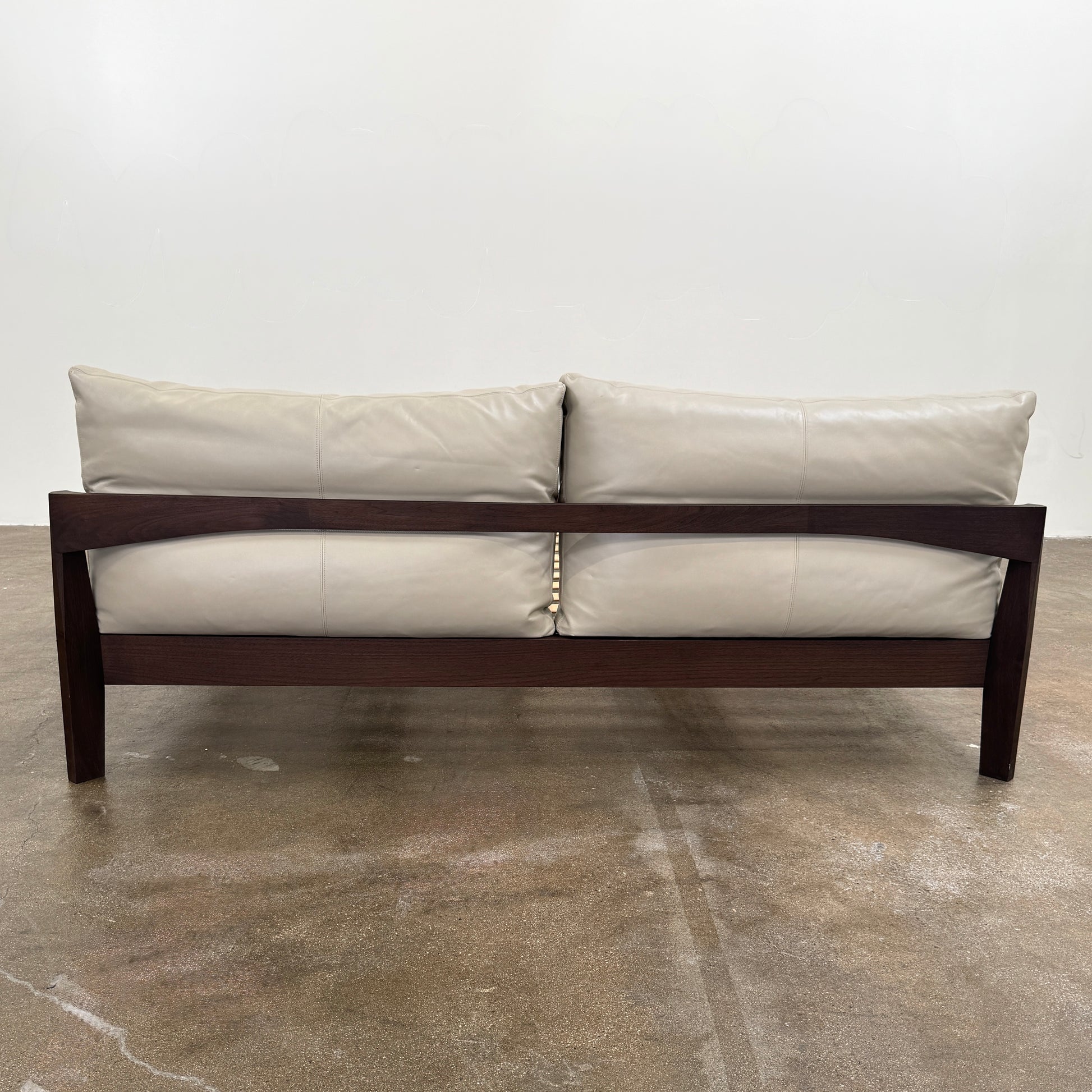 The Molteni&C Wish King Size Bed by Molteni & C features a solid wood frame with a slatted base, dark brown legs, and two large beige headboard cushions. Shown on a white background, it’s ideal for stylish and comfortable bedrooms.
