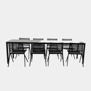 The Tribu Illum Outdoor Dining Table with 8 Chairs by Modern Resale features a sleek black finish and matching seating, set against a plain white background—an elegant choice for any modern outdoor space.
