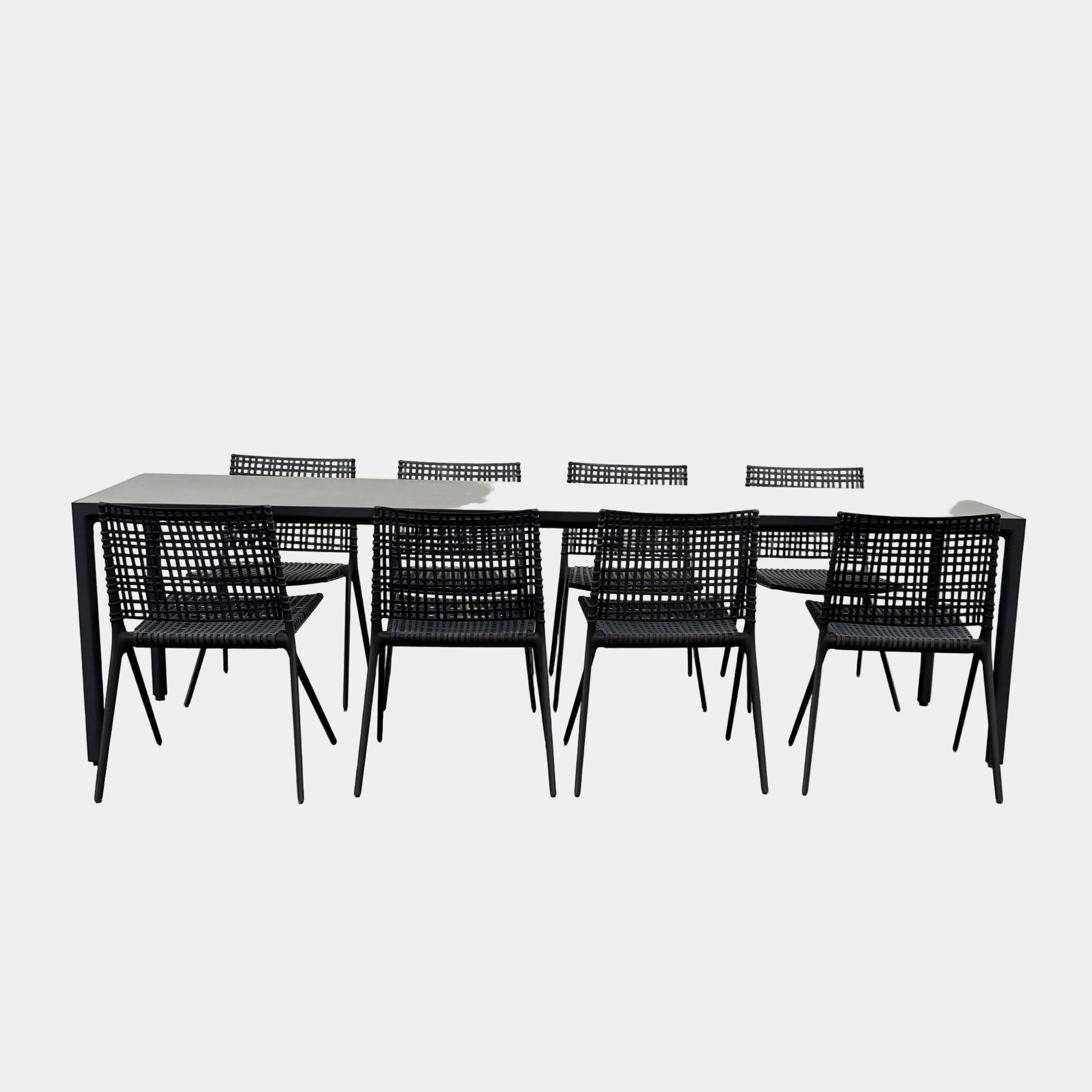 The Tribu Illum Outdoor Dining Table with 8 Chairs by Modern Resale features a sleek black finish and matching seating, set against a plain white background—an elegant choice for any modern outdoor space.