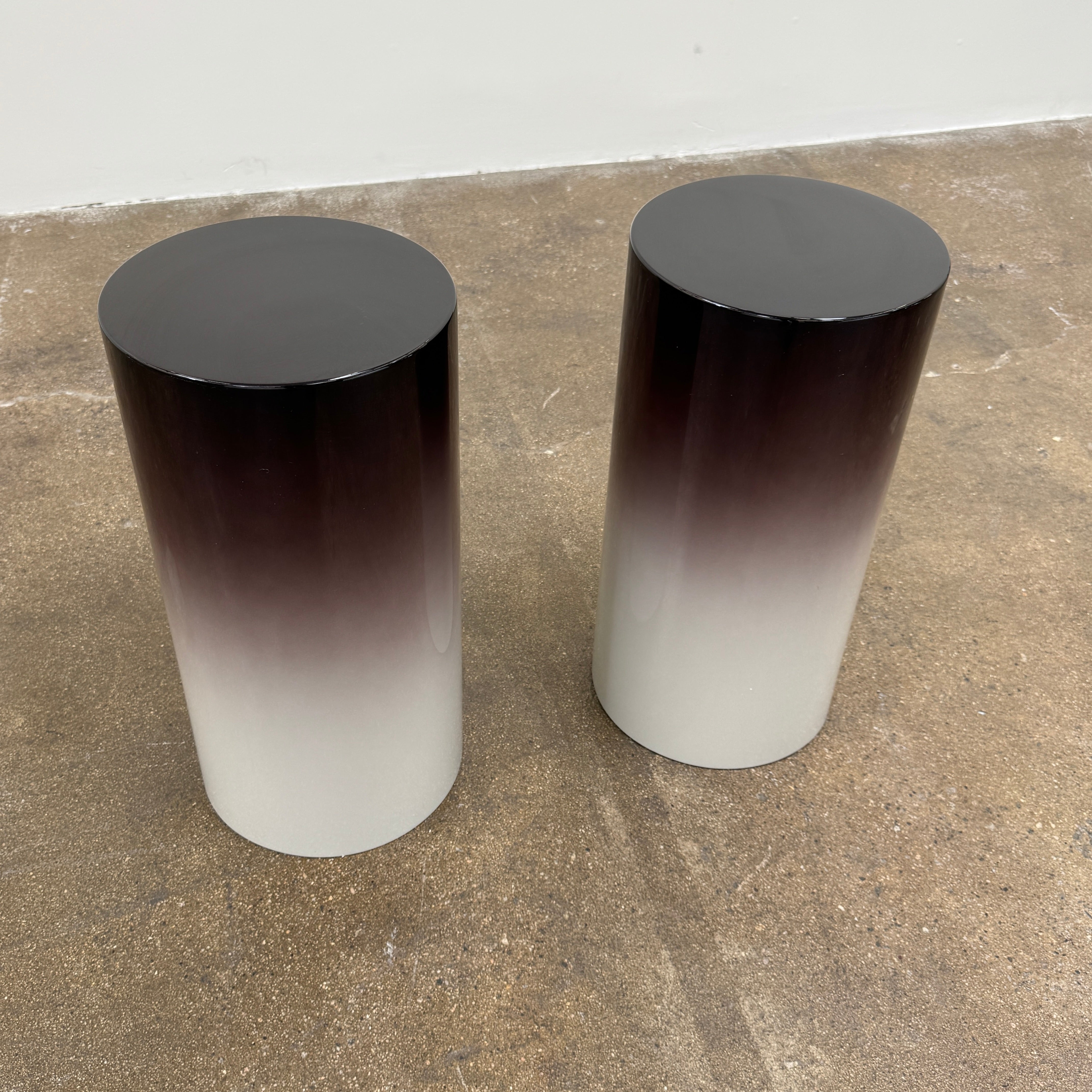 The Minotti Pilotis Accent Table by Minotti features a cylindrical form with a sleek gradient from black to white, adding a modern touch and elevating any contemporary interior furniture collection.