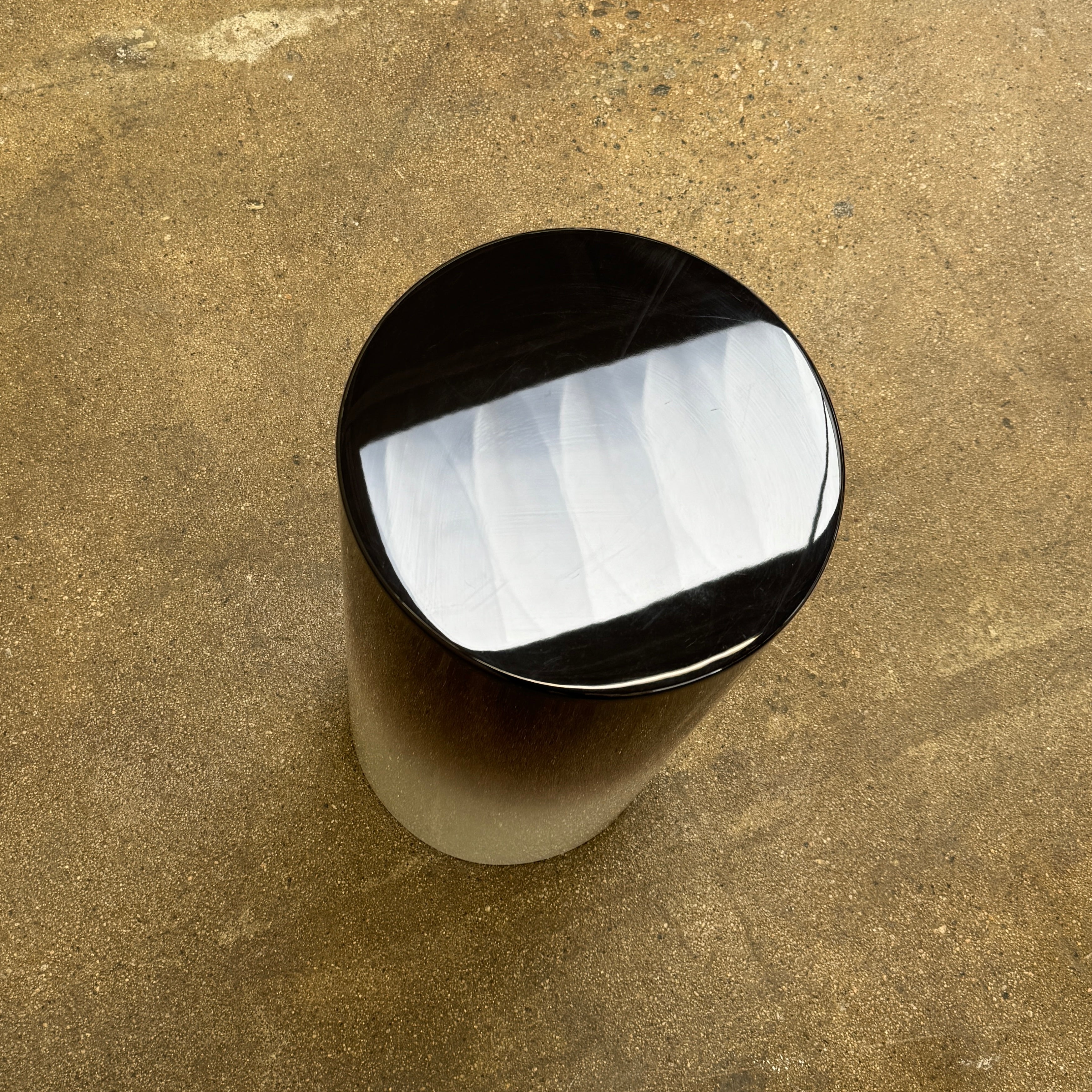 The Minotti Pilotis Accent Table by Minotti features a cylindrical form with a sleek gradient from black to white, adding a modern touch and elevating any contemporary interior furniture collection.