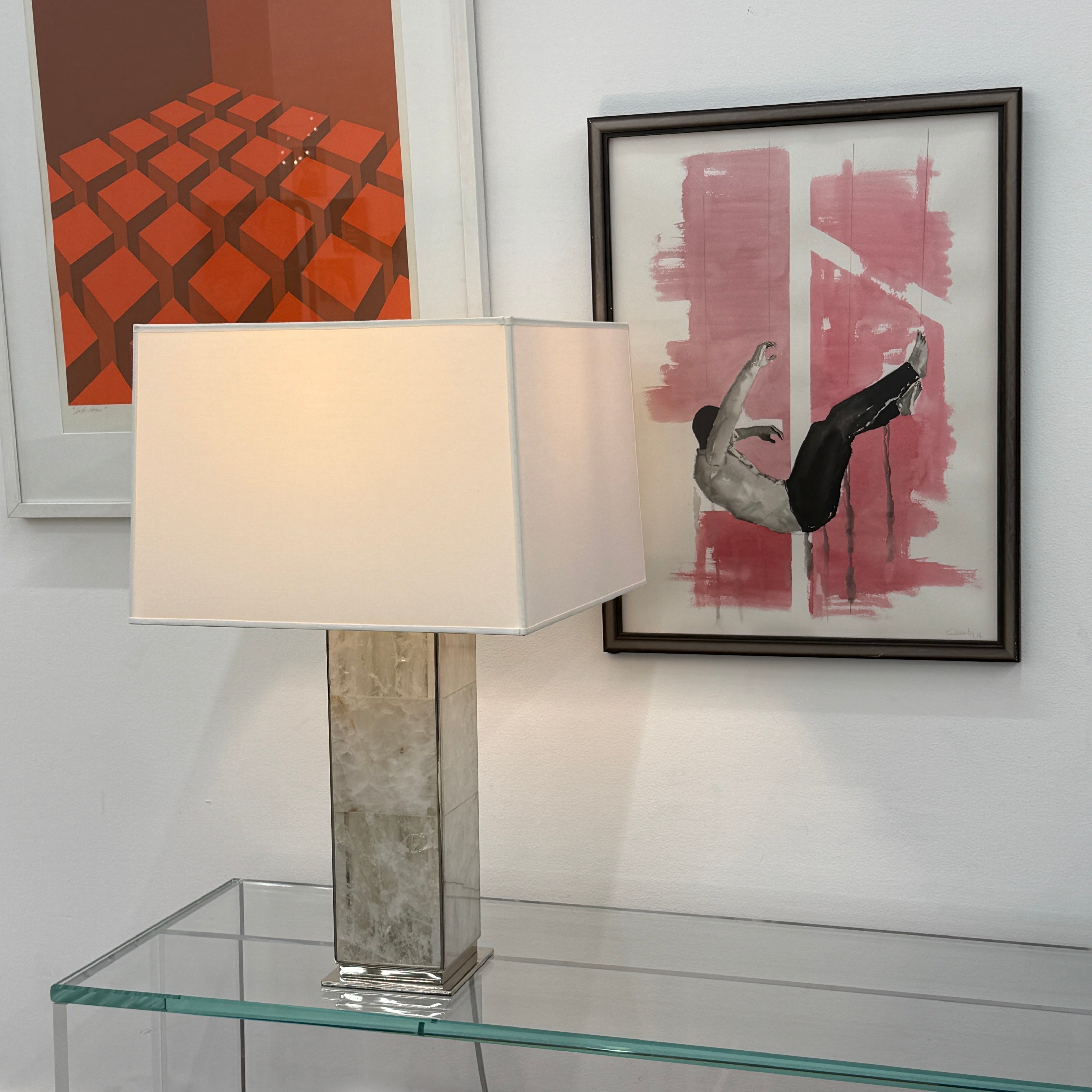 The Visual Comfort Ellis Quartz Table Lamp by Ralph Lauren features a rectangular white shade and a translucent, textured quartz base, shown against a plain white background.