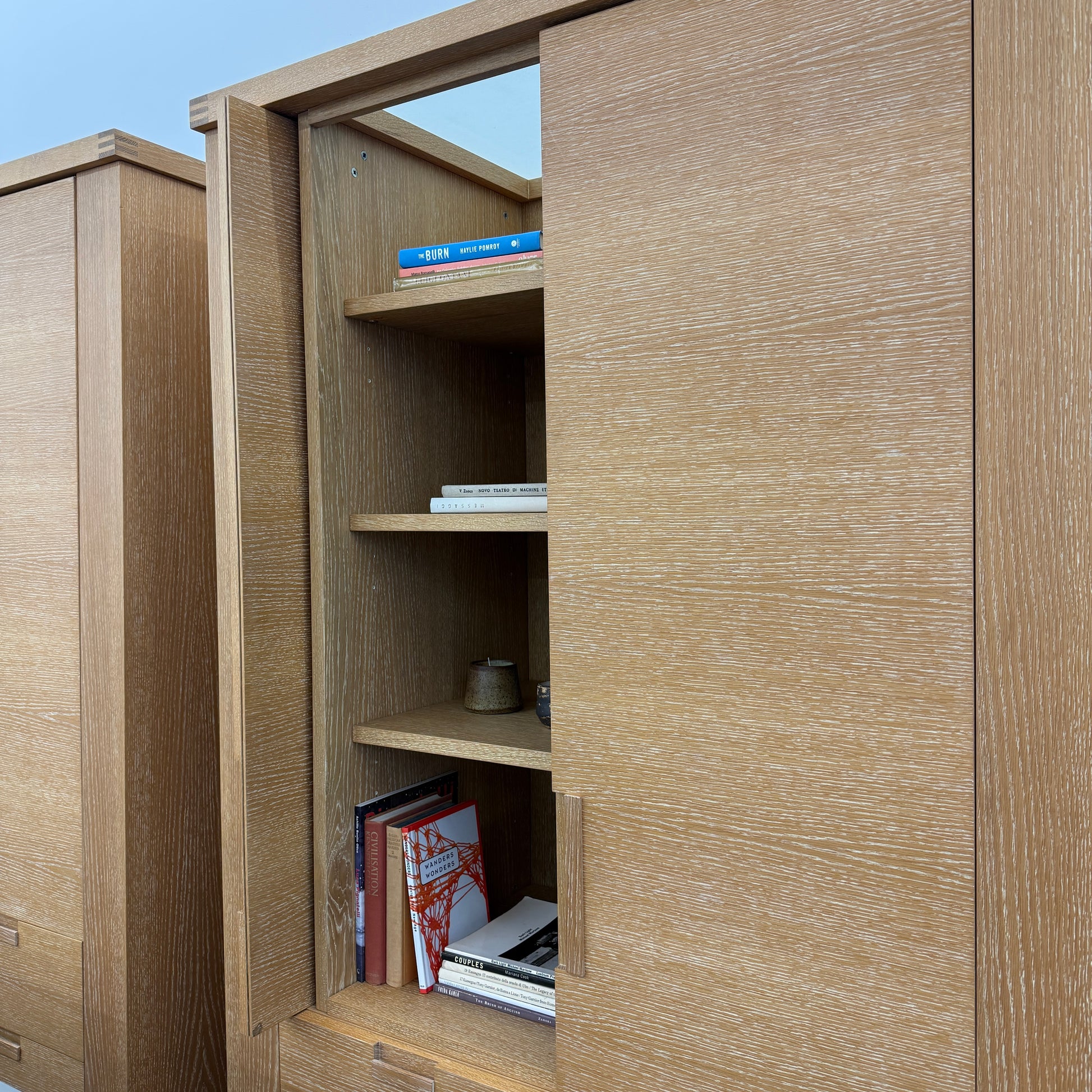 The Maxalto Apta Storage Unit by Maxalto features two vertical doors above and four bottom drawers in two rows, providing versatile storage with convenient shelves and drawers.