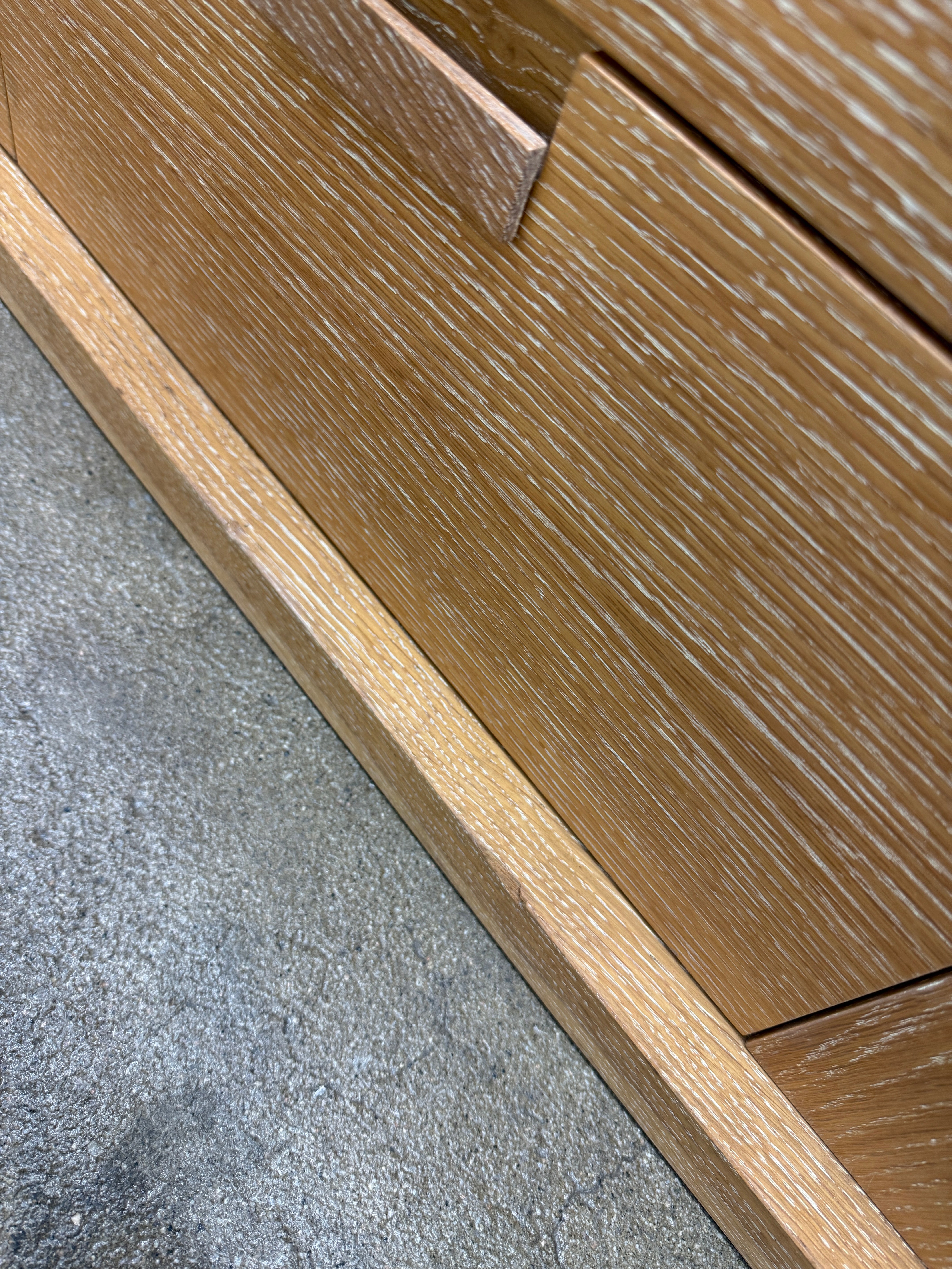 The Maxalto Apta Storage Unit by Maxalto features two vertical doors above and four bottom drawers in two rows, providing versatile storage with convenient shelves and drawers.