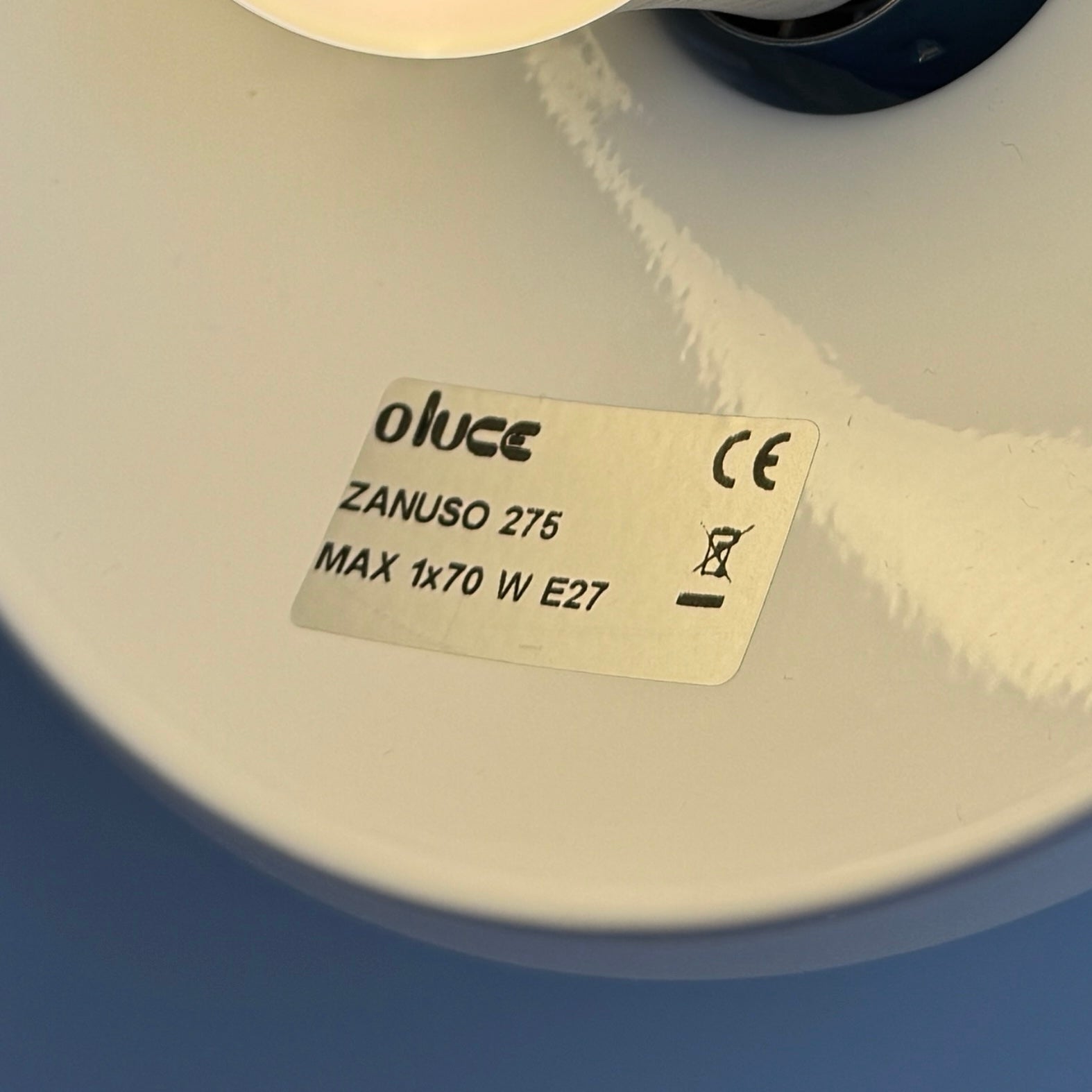 The Oluce Zanuso 275 Table Light by Oluce is a modern lamp inspired by Italian design, with a white domed glass shade, orange base, and black power cord with switch, shown against a plain background.