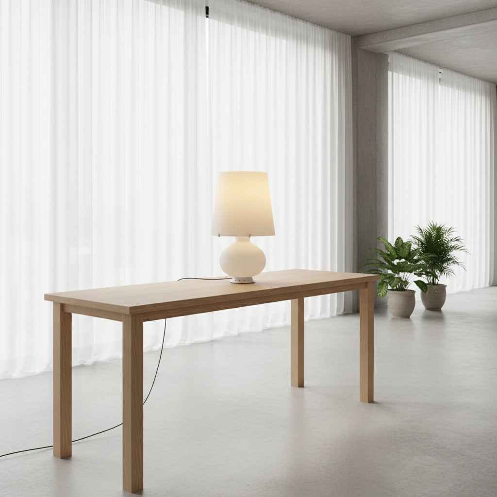 The Fontana Arte Table Lamp - Medium by Fontana Arte features a modernist design with a round base and wide, tapered lampshade, displayed against a plain light background.