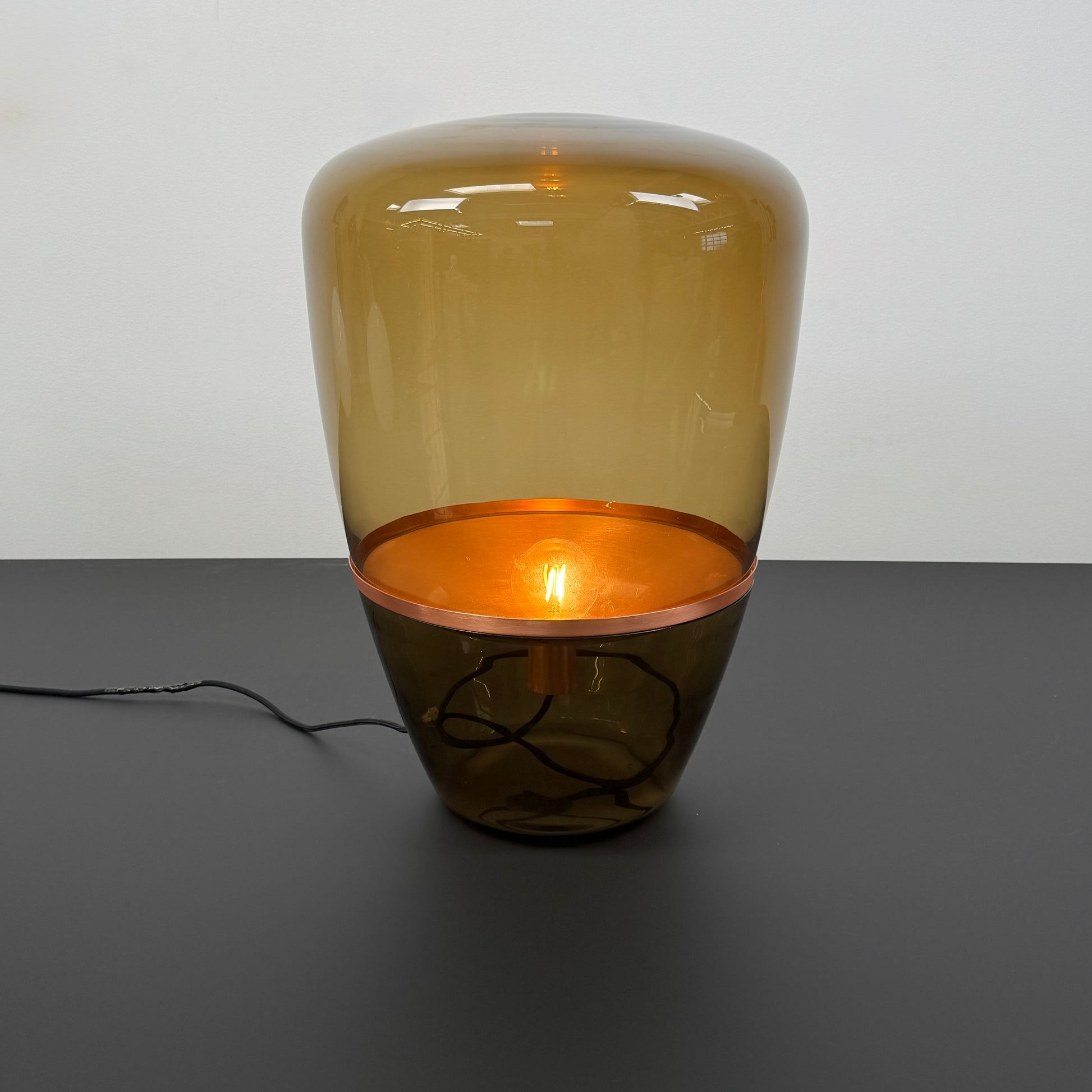 Three Brokis Balloons LED Lamps with handblown glass and copper accents are arranged side by side against a white background, highlighting their elegant sculptural design.
