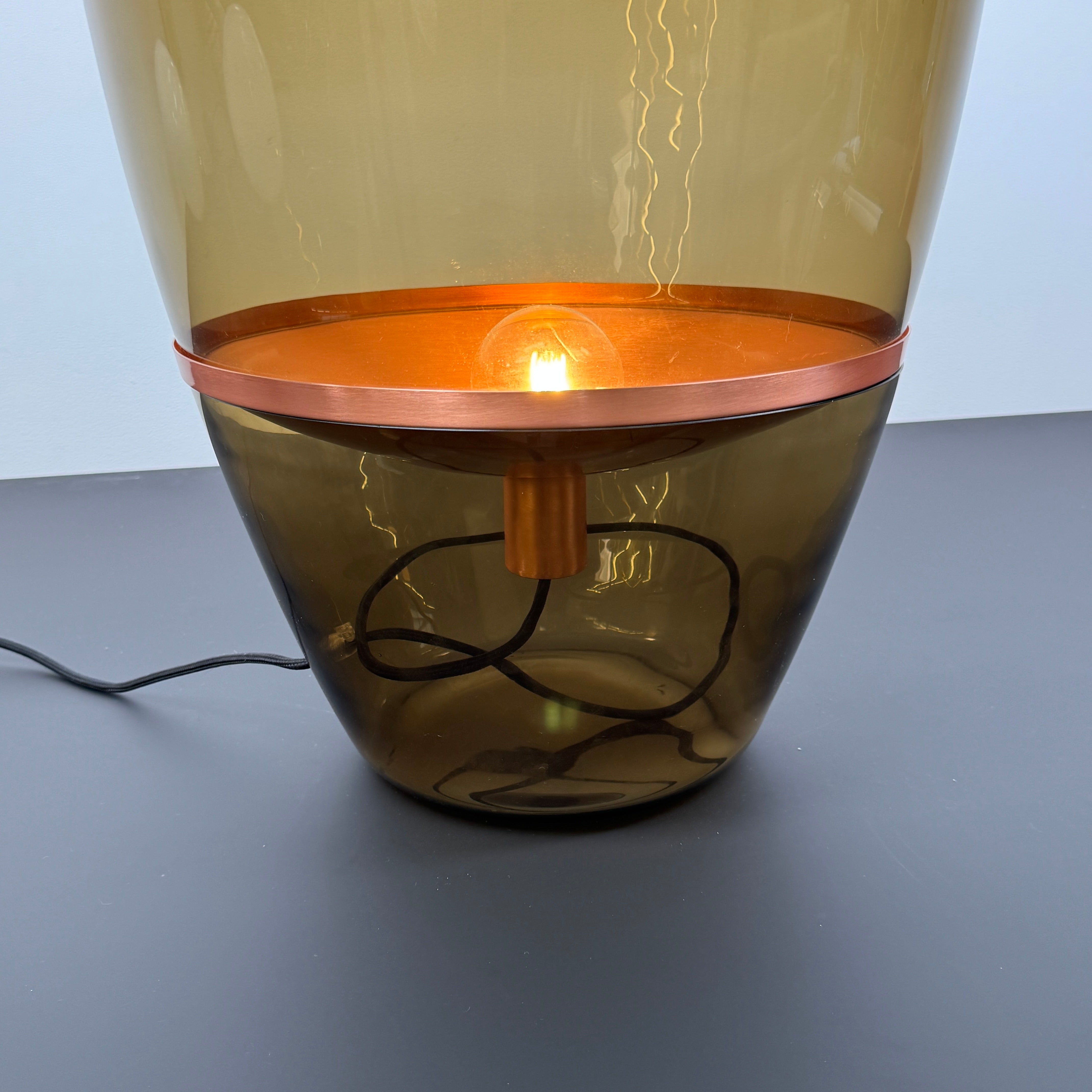 Three Brokis Balloons LED Lamps with handblown glass and copper accents are arranged side by side against a white background, highlighting their elegant sculptural design.