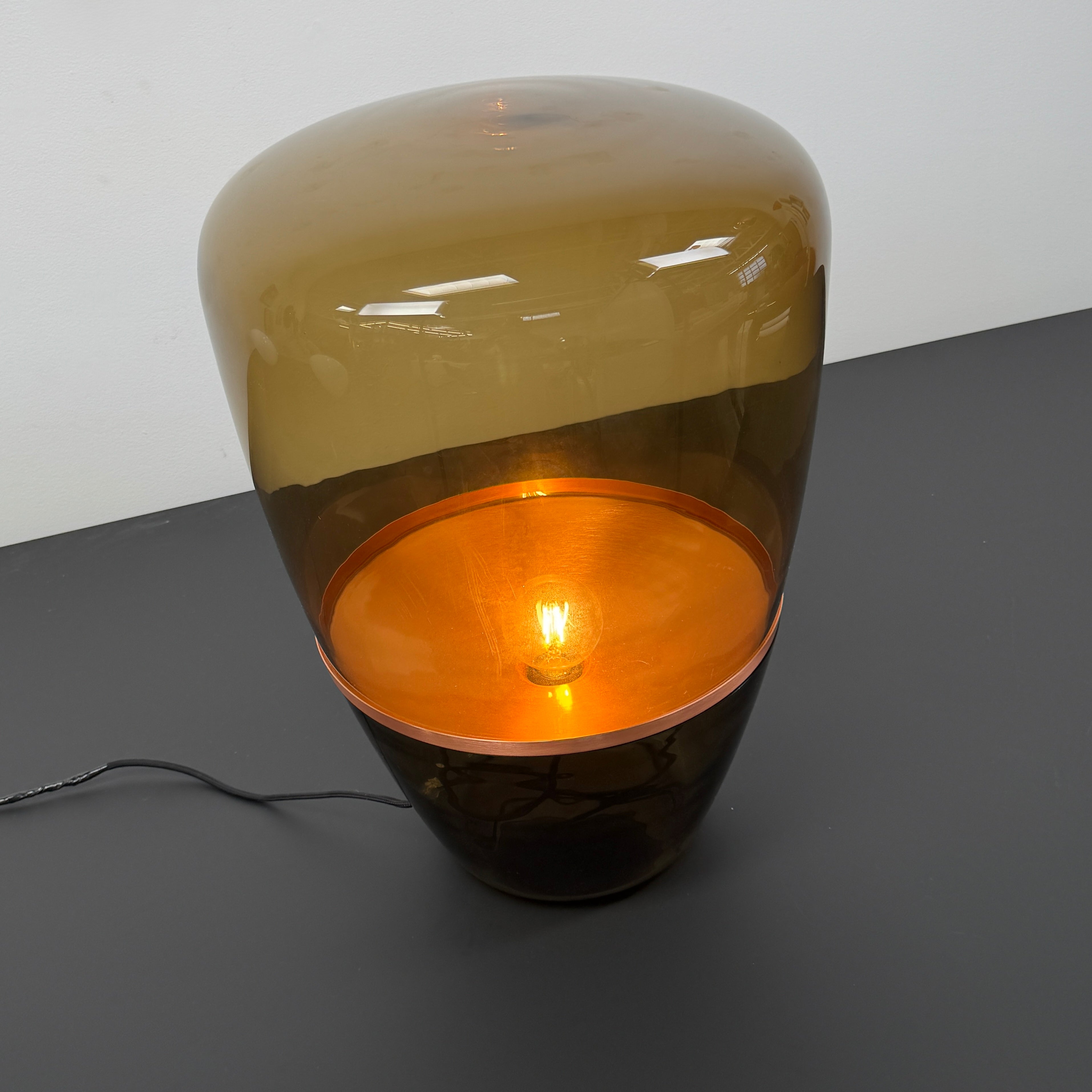 Three Brokis Balloons LED Lamps with handblown glass and copper accents are arranged side by side against a white background, highlighting their elegant sculptural design.