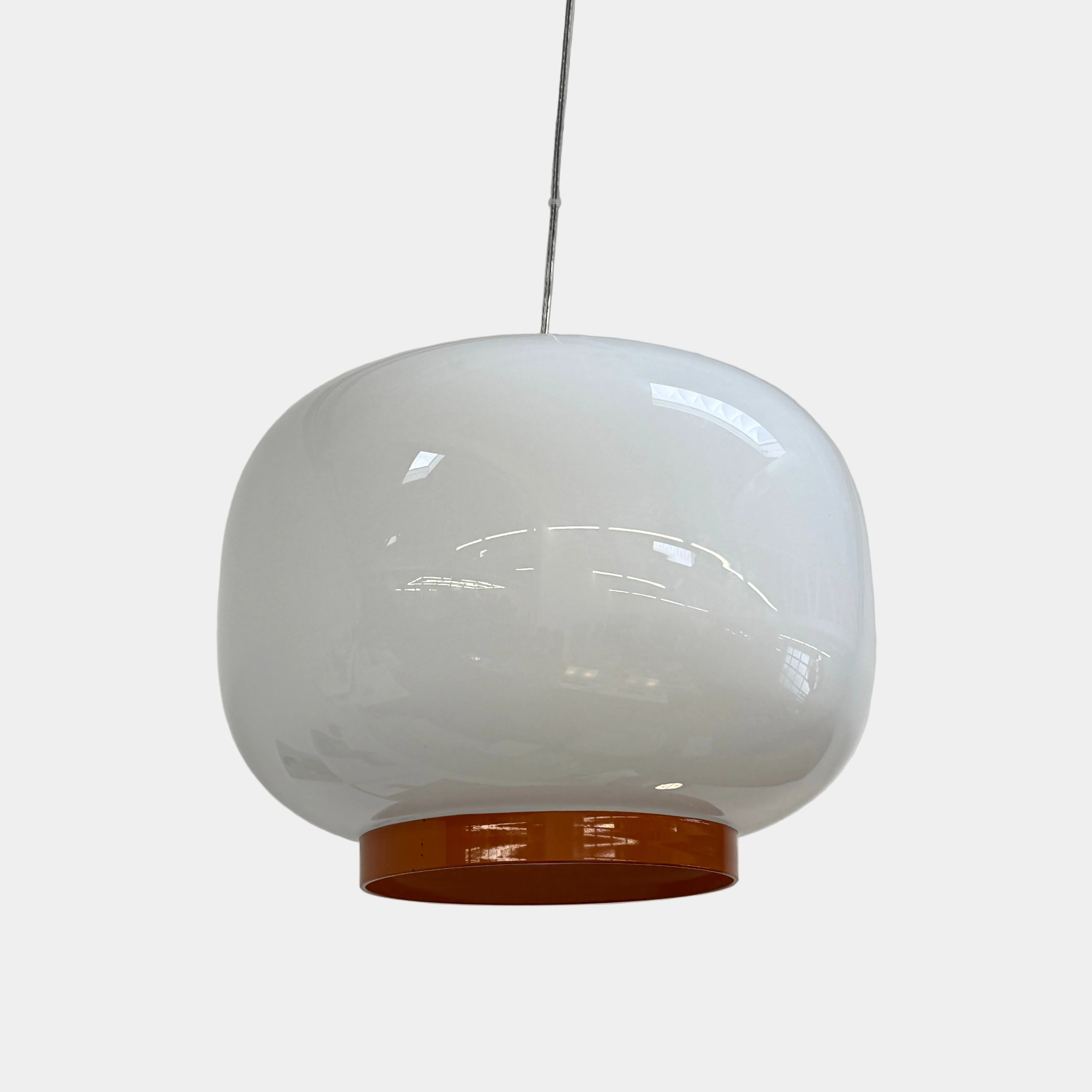 The Foscarini Chouchin 1 Pendant by Foscarini features a glossy white, rounded glass shade with a brown base, suspended on a single cable—evoking the style of a Japanese paper lantern.