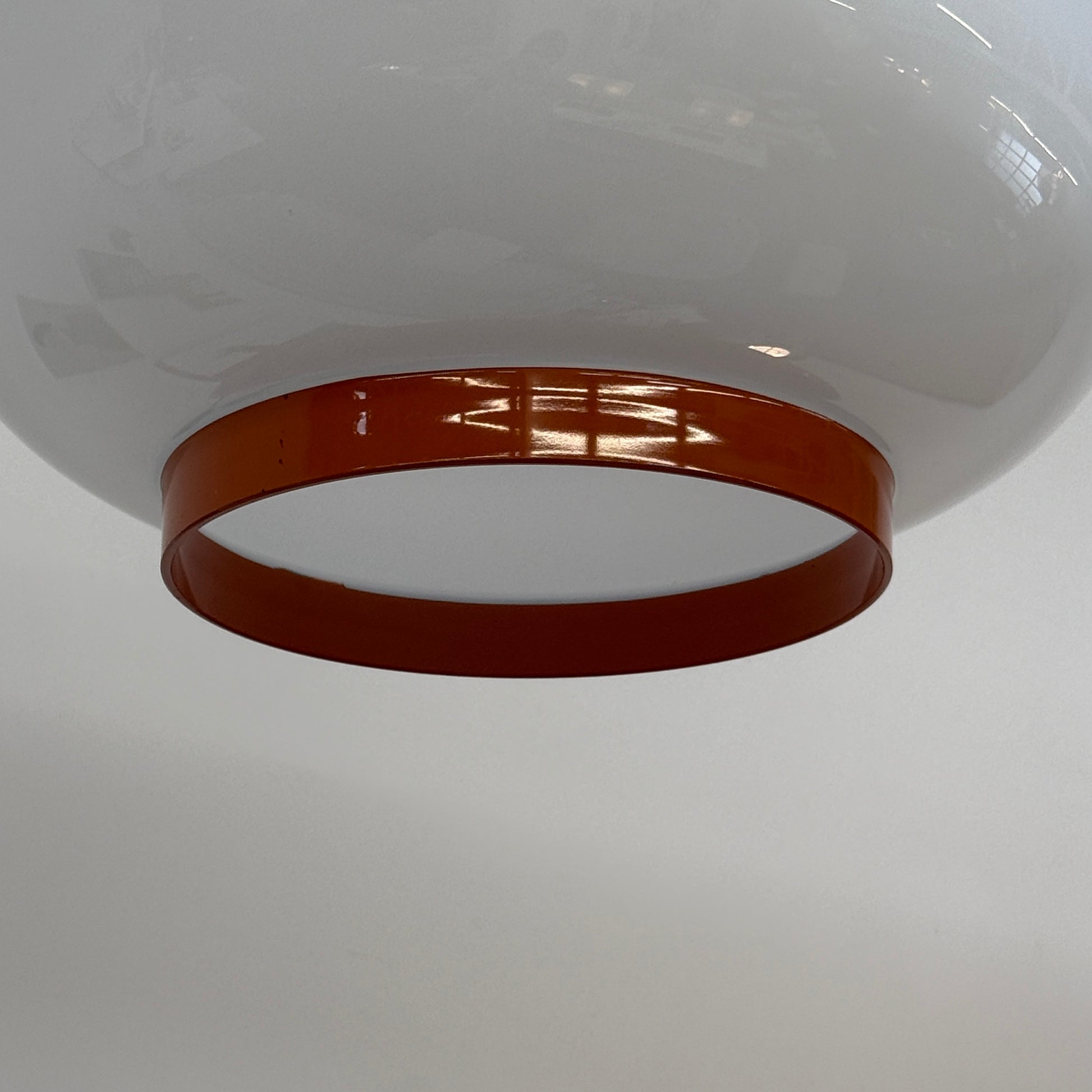 The Foscarini Chouchin 1 Pendant by Foscarini features a glossy white, rounded glass shade with a brown base, suspended on a single cable—evoking the style of a Japanese paper lantern.