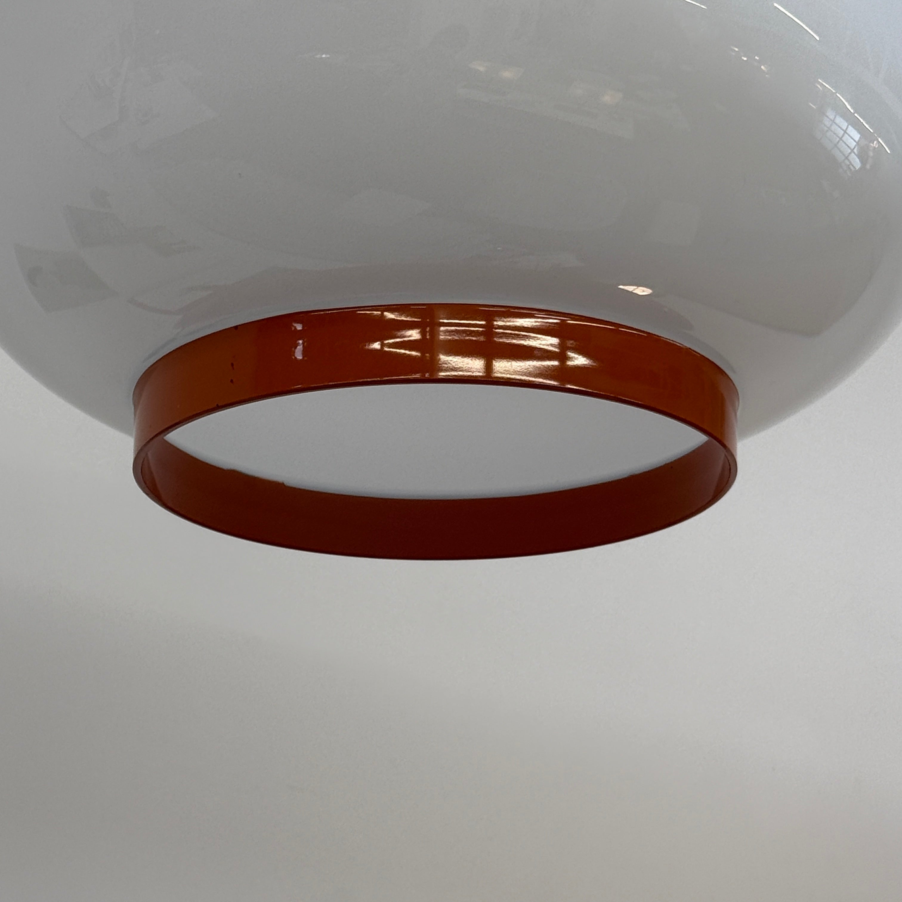 The Foscarini Chouchin 1 Pendant by Foscarini features a glossy white, rounded glass shade with a brown base, suspended on a single cable—evoking the style of a Japanese paper lantern.