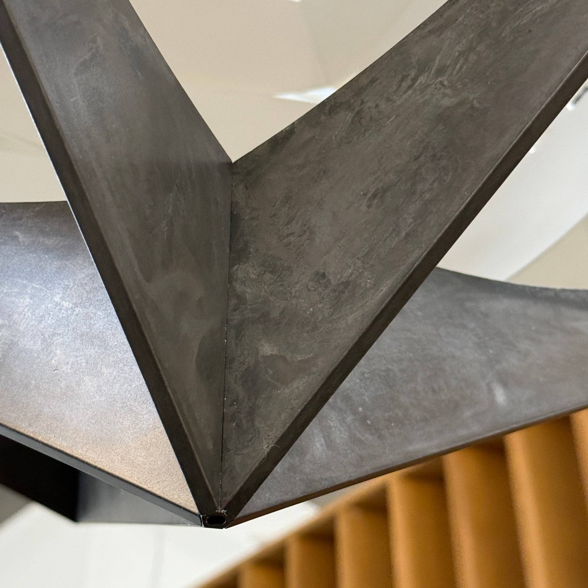 The Louis Poulsen OE Quasi Pendant is a sculptural geometric light fixture featuring a black outer frame and layered white panels, elegantly suspended by a cord—a modern design by Louis Poulsen.