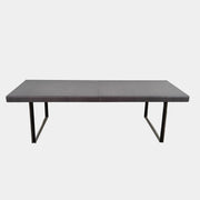 The B&B Italia Athos 12 Extendable Dining Table by Paolo Piva features a sleek rectangular dark gray top and black metal legs, showcased against a plain white background.