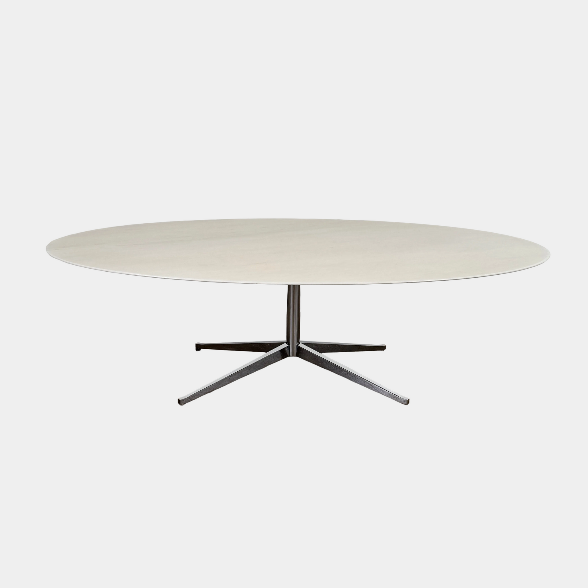 Florence Knoll’s DWR Florence Knoll Oval White Statuarietto Marble "Table Desk" features a slim marble top and black four-legged base, inspired by the iconic design, displayed against a plain white background.