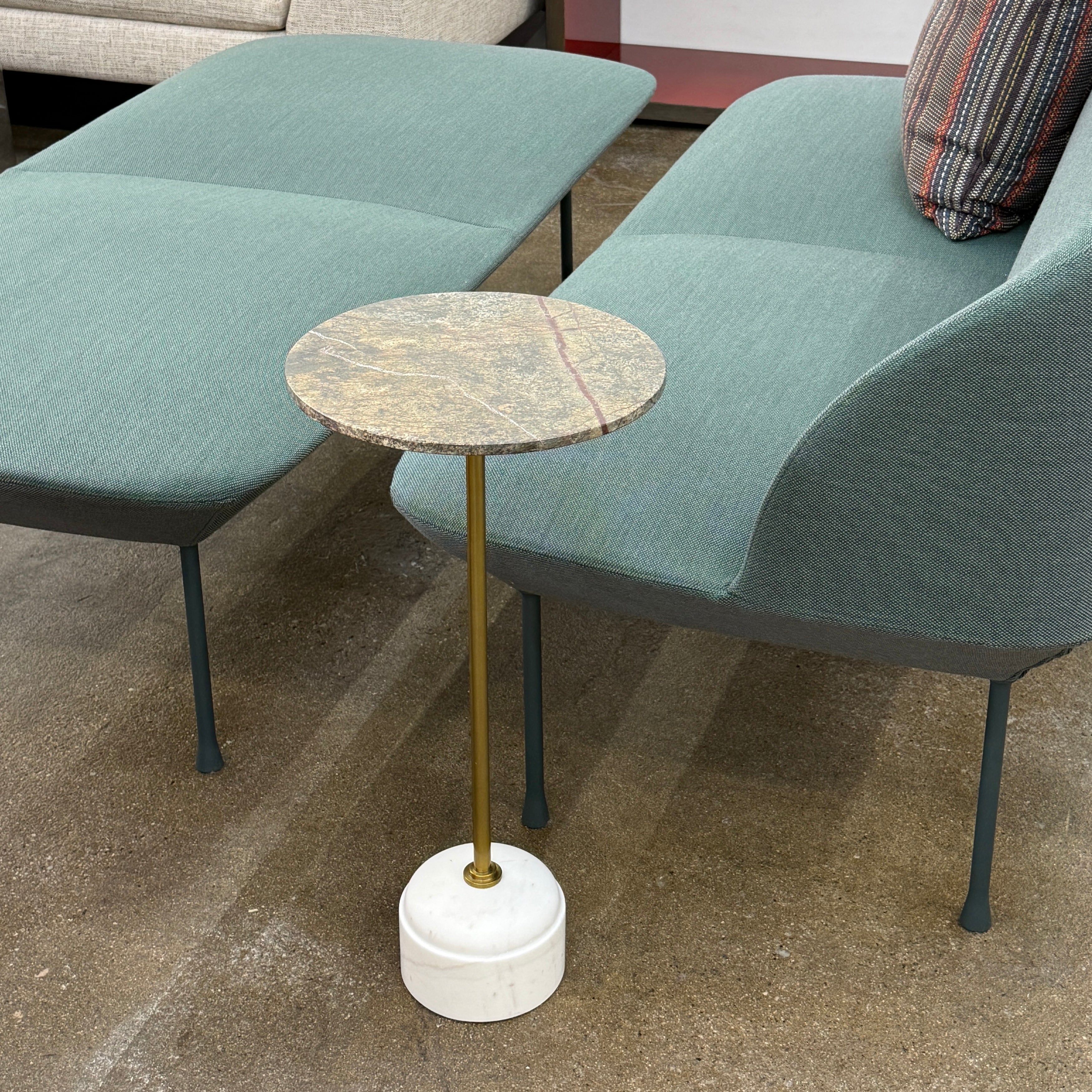 The Soho Home Fleet Side Table by Soho Home features a dark Verde Bosque marble top, slender antique brass stem, and a white cylindrical marble base, shown against a plain light background.
