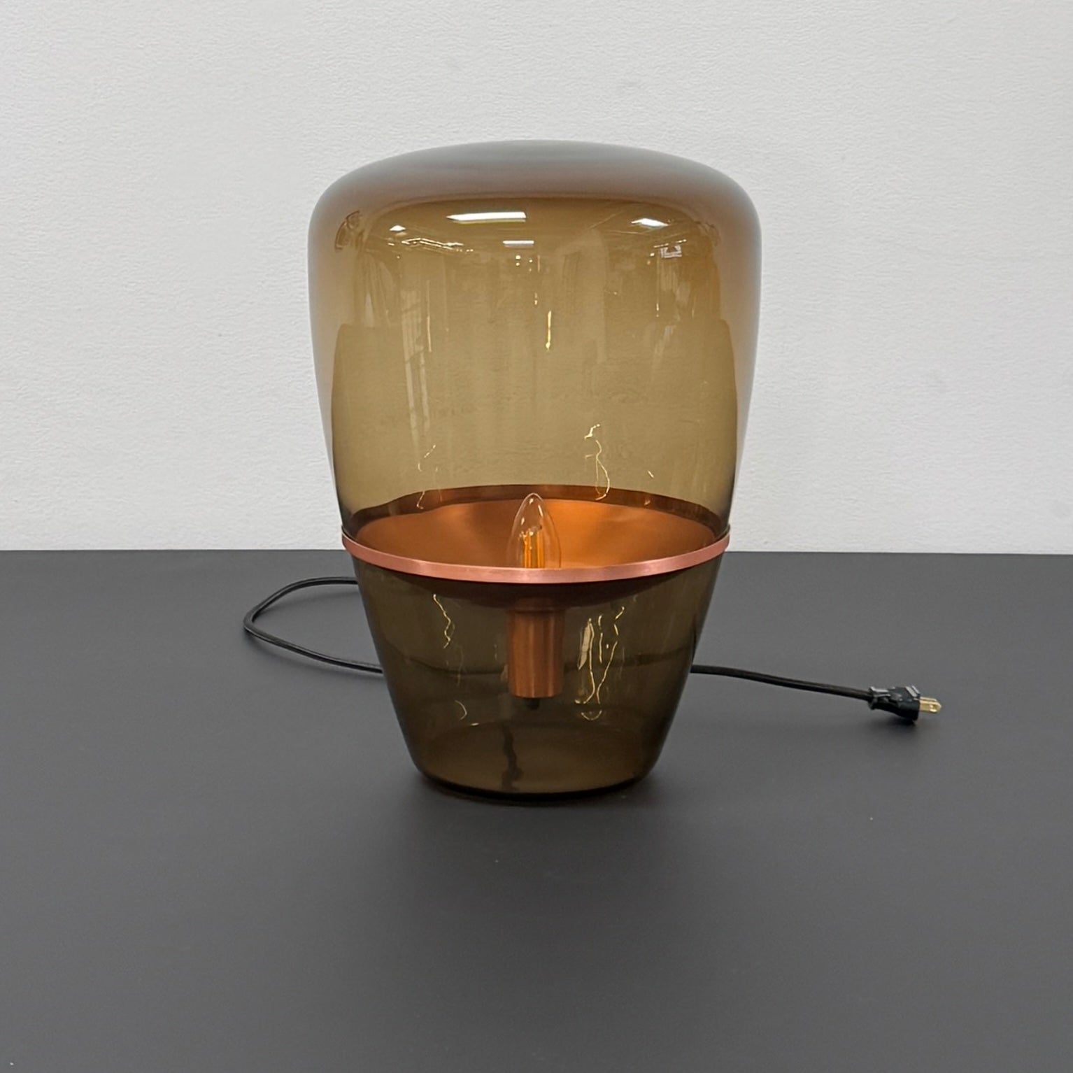 Three Brokis Balloons LED Lamps with handblown glass and copper accents are arranged side by side against a white background, highlighting their elegant sculptural design.