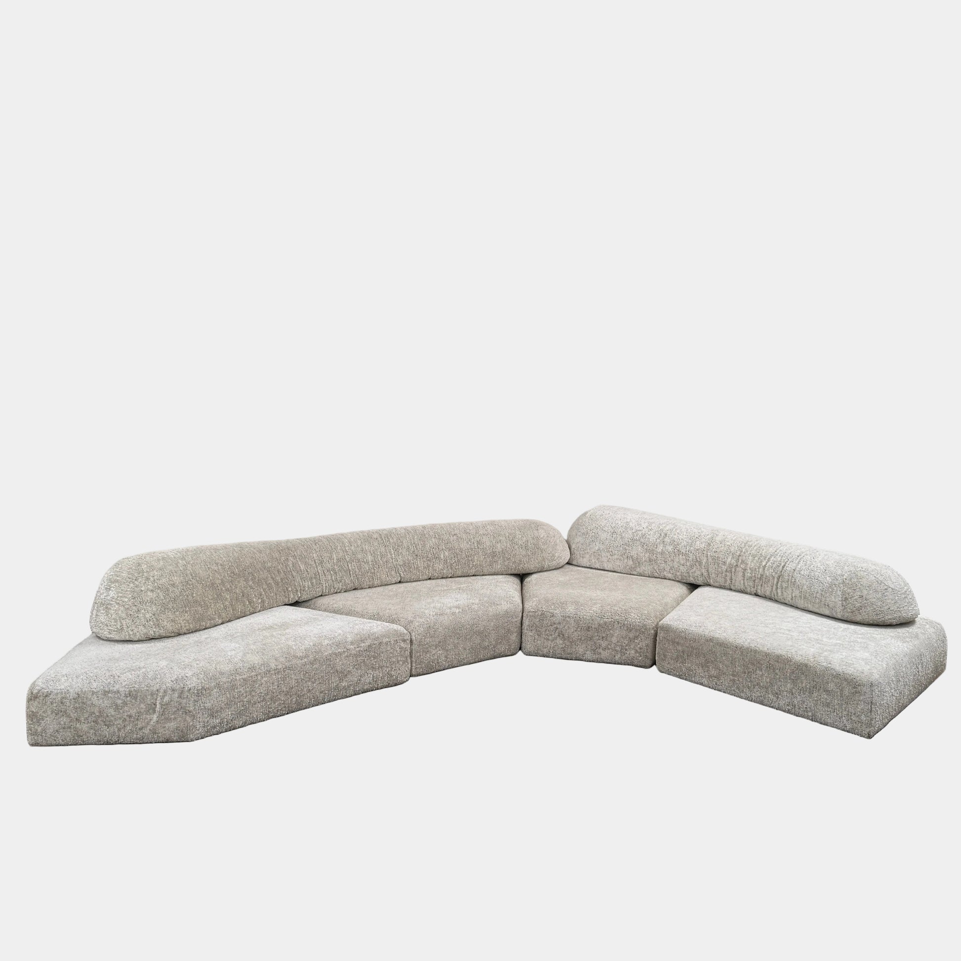 The Edra On The Rocks 4 piece Modular Sofa by Edra is a modern, light gray L-shaped sofa with customizable seating, featuring low rounded backrests and wide flat cushions, shown on a plain white background.