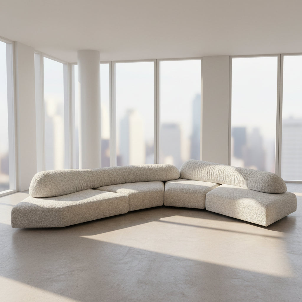 The Edra On The Rocks 4 piece Modular Sofa by Edra is a modern, light gray L-shaped sofa with customizable seating, featuring low rounded backrests and wide flat cushions, shown on a plain white background.