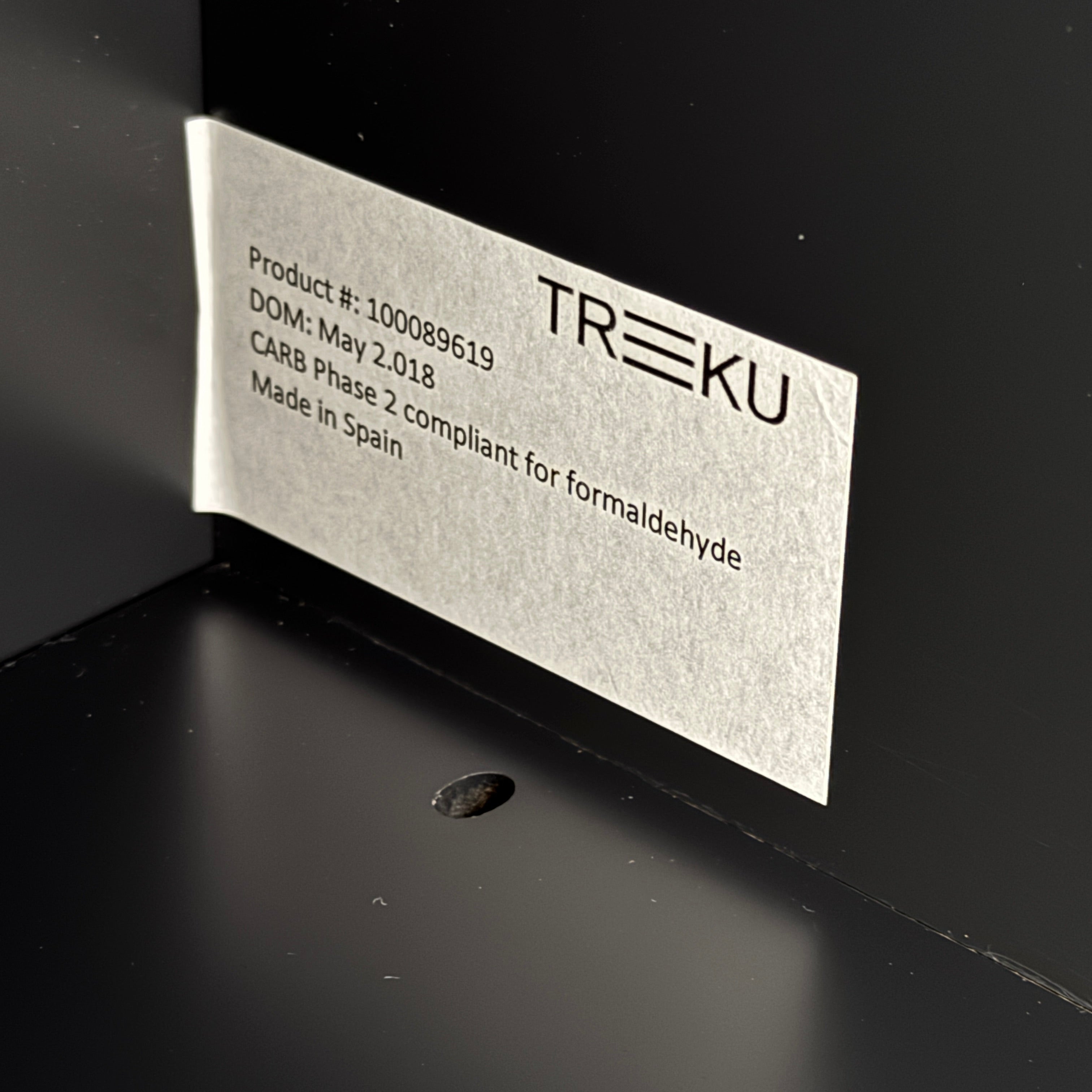 The Treku Lauki Media Unit by Treku features a black minimalist design with two closed side cabinets, two central drawers, an open shelf, and built-in cord management on slim metal legs—perfect for modern spaces.
