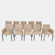 A set of Walter Knoll Deen Dining Chairs (2 armchairs, 8 side chairs) by Walter Knoll with beige upholstery and black legs are arranged in three rows on a brown concrete floor against a plain white wall.