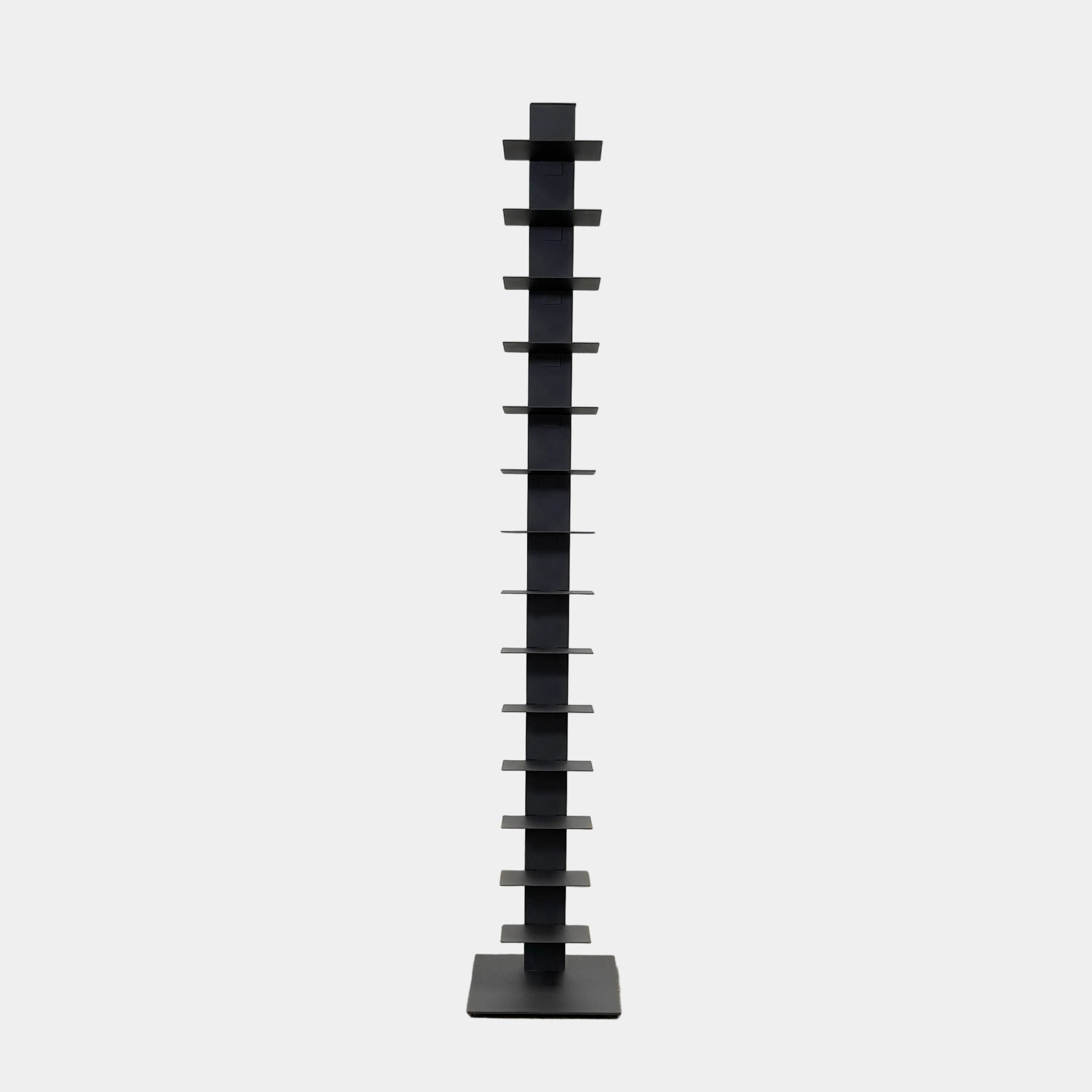 The DWR Story Bookcase by DWR is a tall, black, vertical metal bookcase with evenly spaced shelves and a square base—ideal for small-room storage and shown against a plain light background.